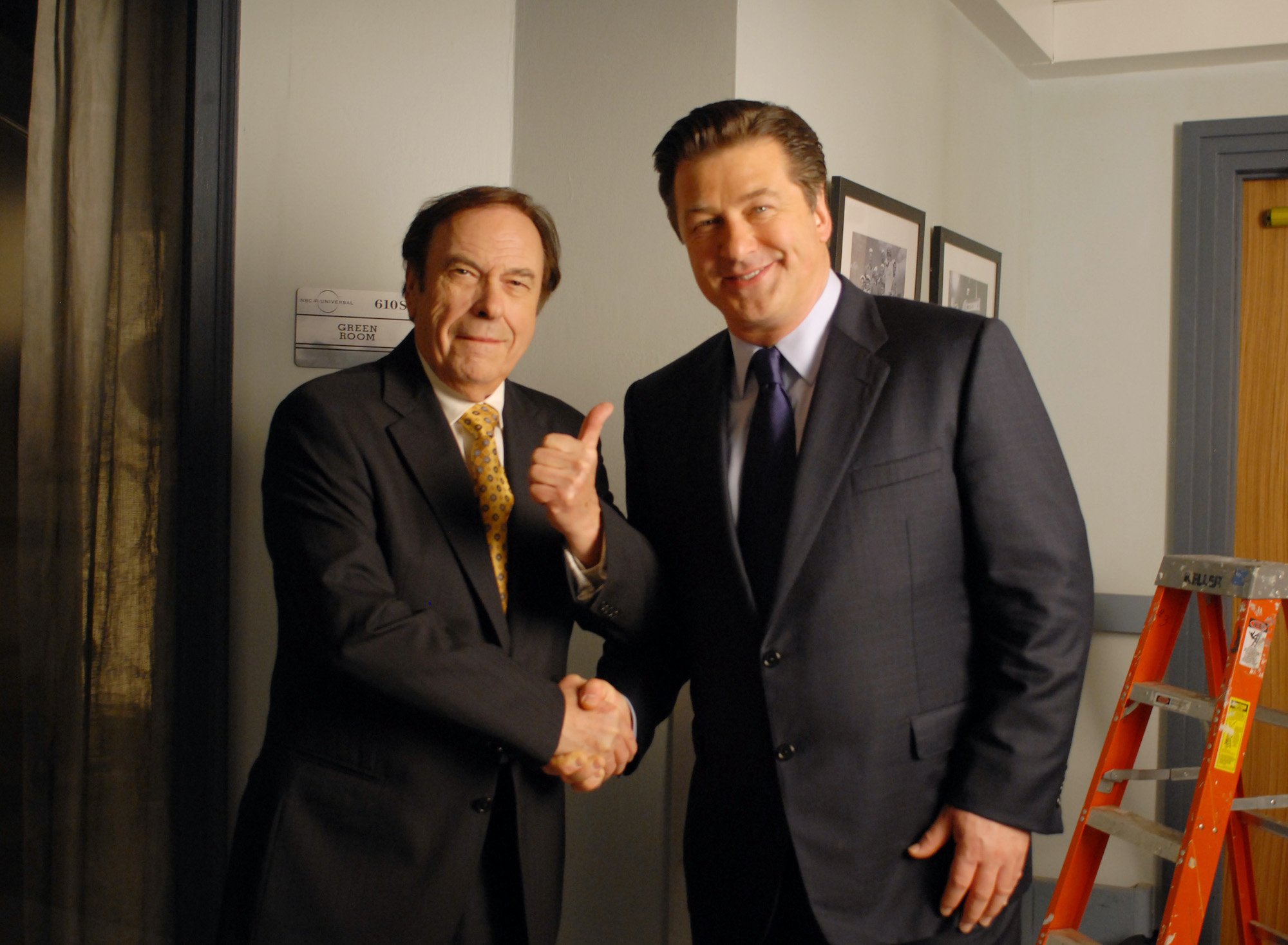 Rip Torn and Alec Baldwin shaking hands, smiling at the camera, on '30 Rock'