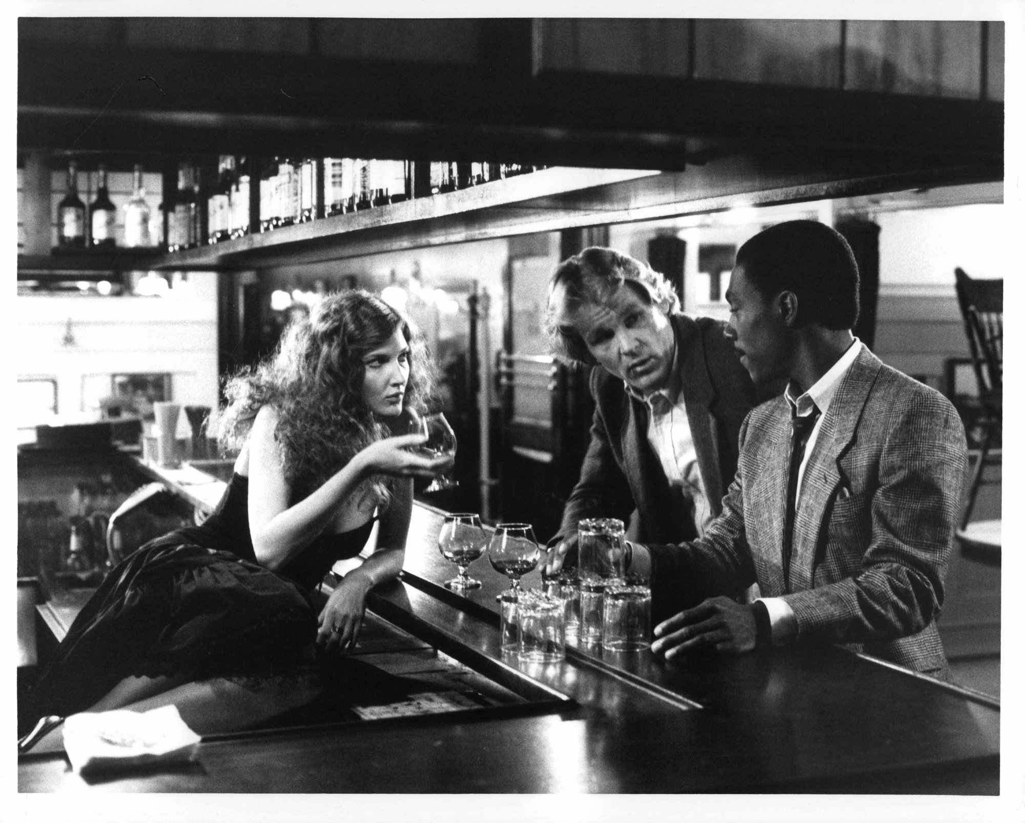 48 Hours: Eddie Murphy and Nick Nolte stand at a bar with Annette O'Toole