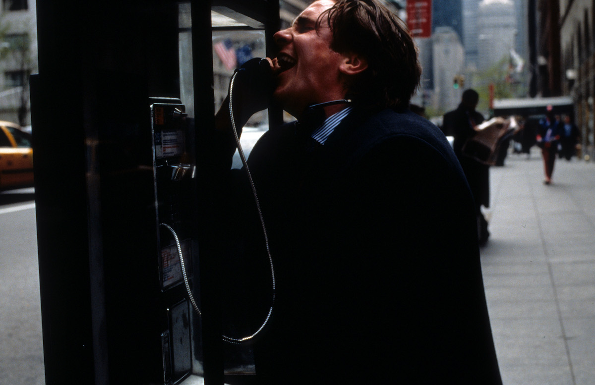 Christian Bale at pay phone in a scene from 'American Psycho'