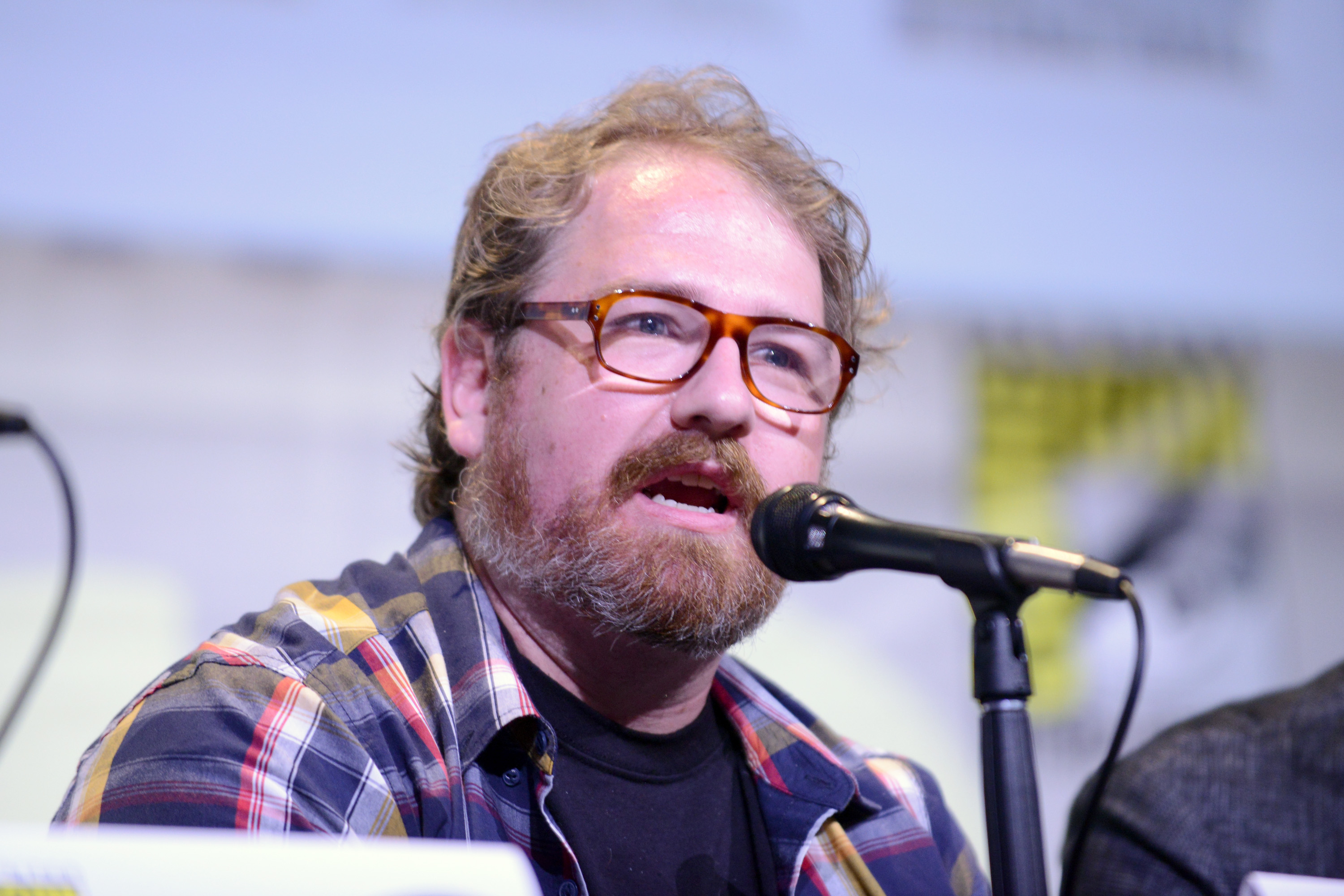 'Supernatural' co-showrunner Andrew Dabb speaking into microphone on a Comic-Con panel
