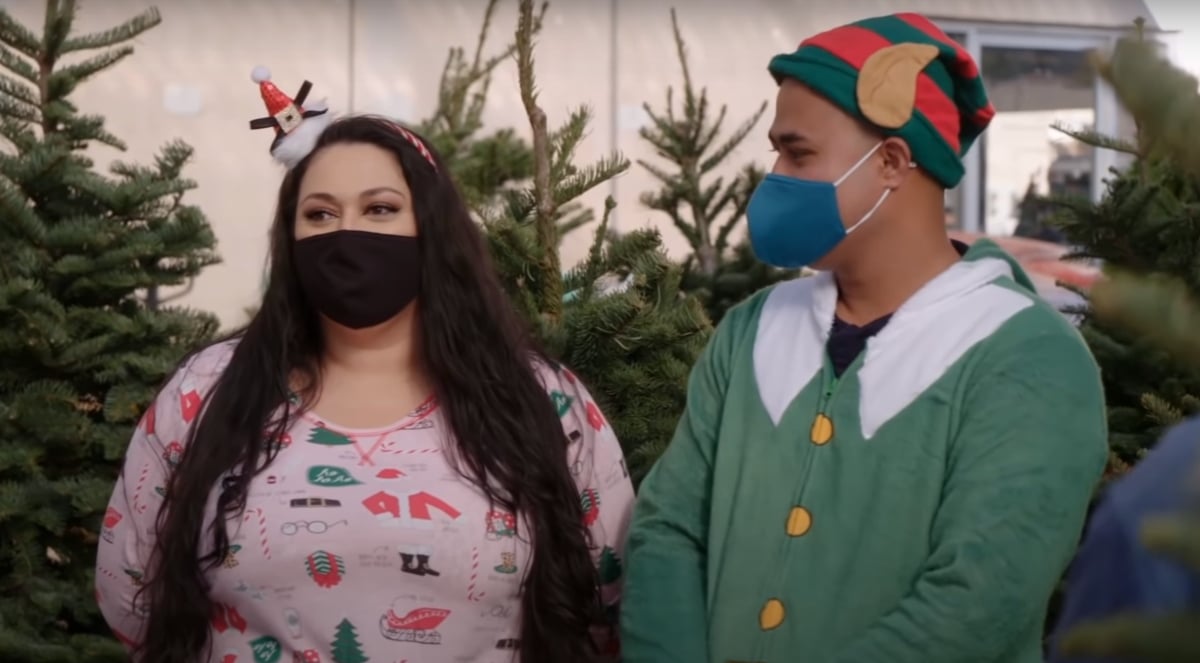 Asuelu Pulaa and Kalani Faagata dressed up in Christmas pajamas looking at Christmas trees on '90 Day Fiancé: Happily Ever After?'