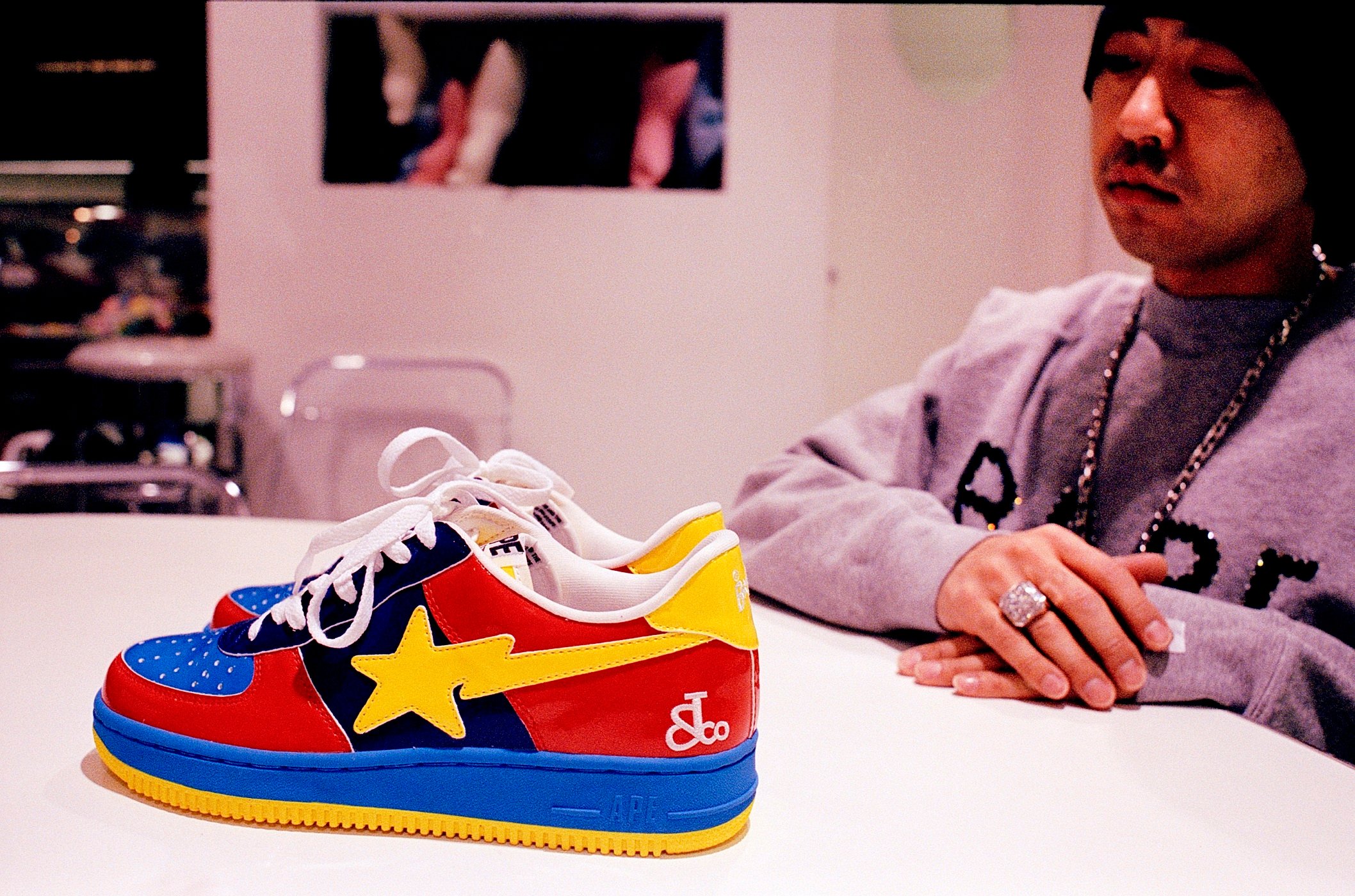 Nigo sits with a version of the Bapesta sneaker in 2004