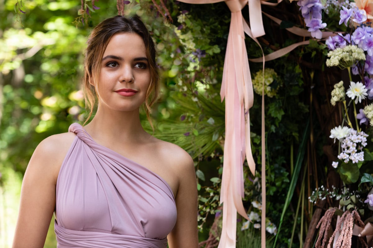 Bailee Madison as Grace wearing a one-shouldered lilac bridesmaid dress in 'Good Witch'