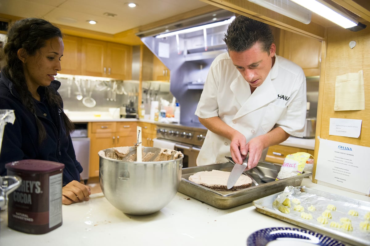 Below Deck's Jennice Ontiveros and chef Ben Robinson work in the kitchen 