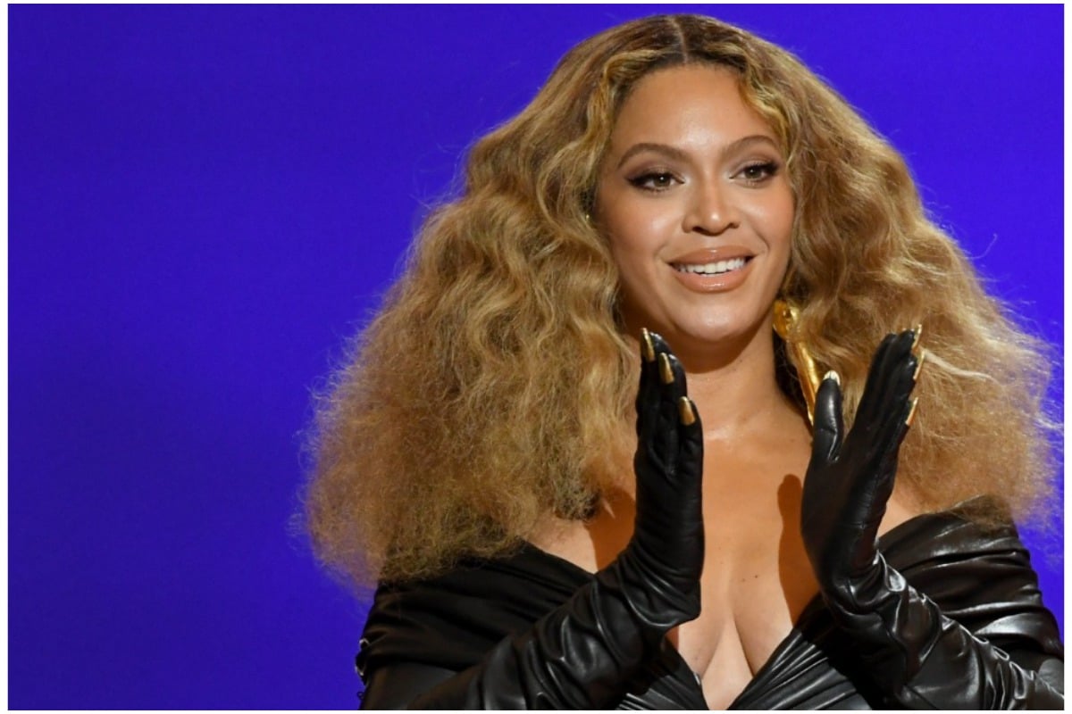 Beyoncé smiling and clapping while attending the 2021 Grammy Awards.