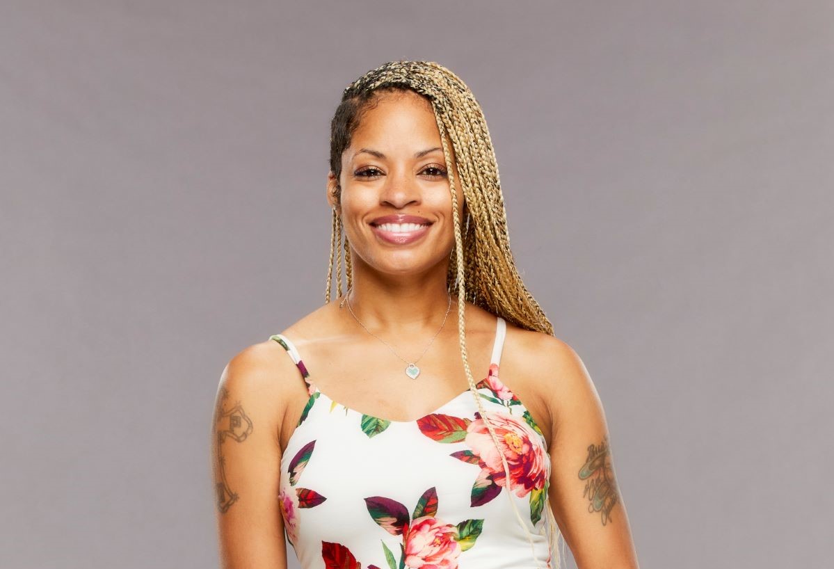 Tiffany Mitchell of 'Big Brother 23' poses in a flower dress in front of a grey background.