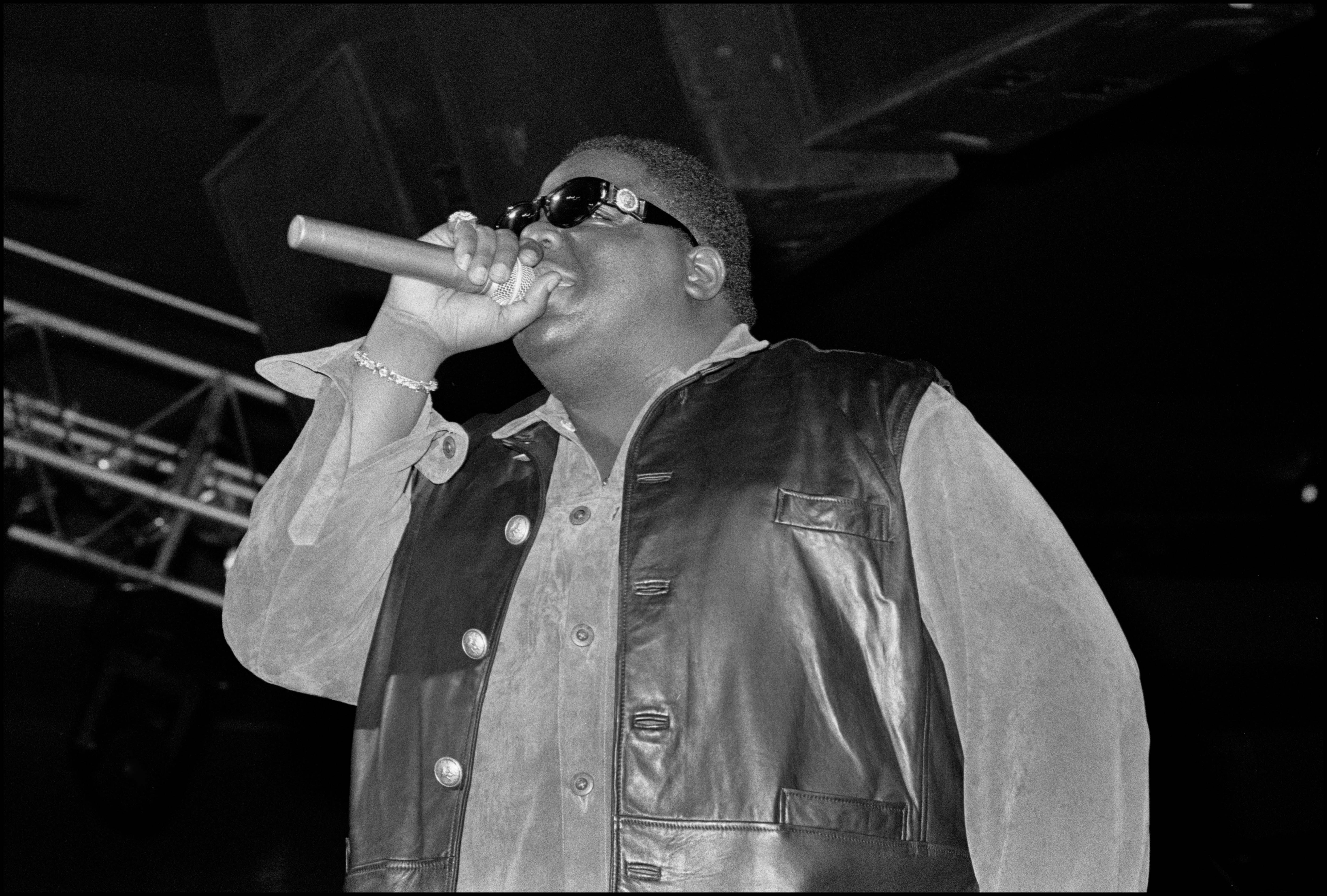 The Notorious B.I.G. performing in a leather jacket