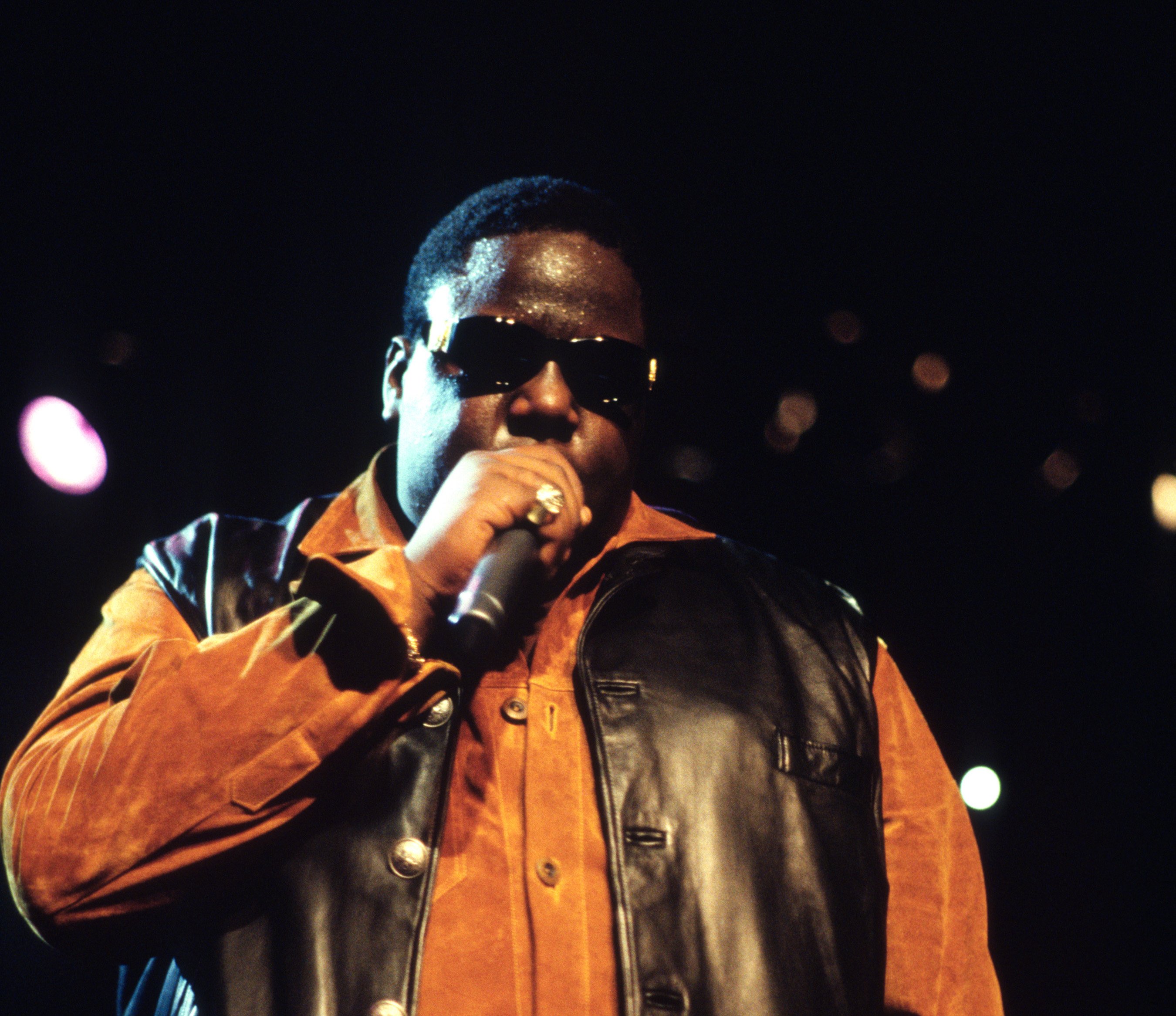 The Notorious B.I.G. performing in a leather vest