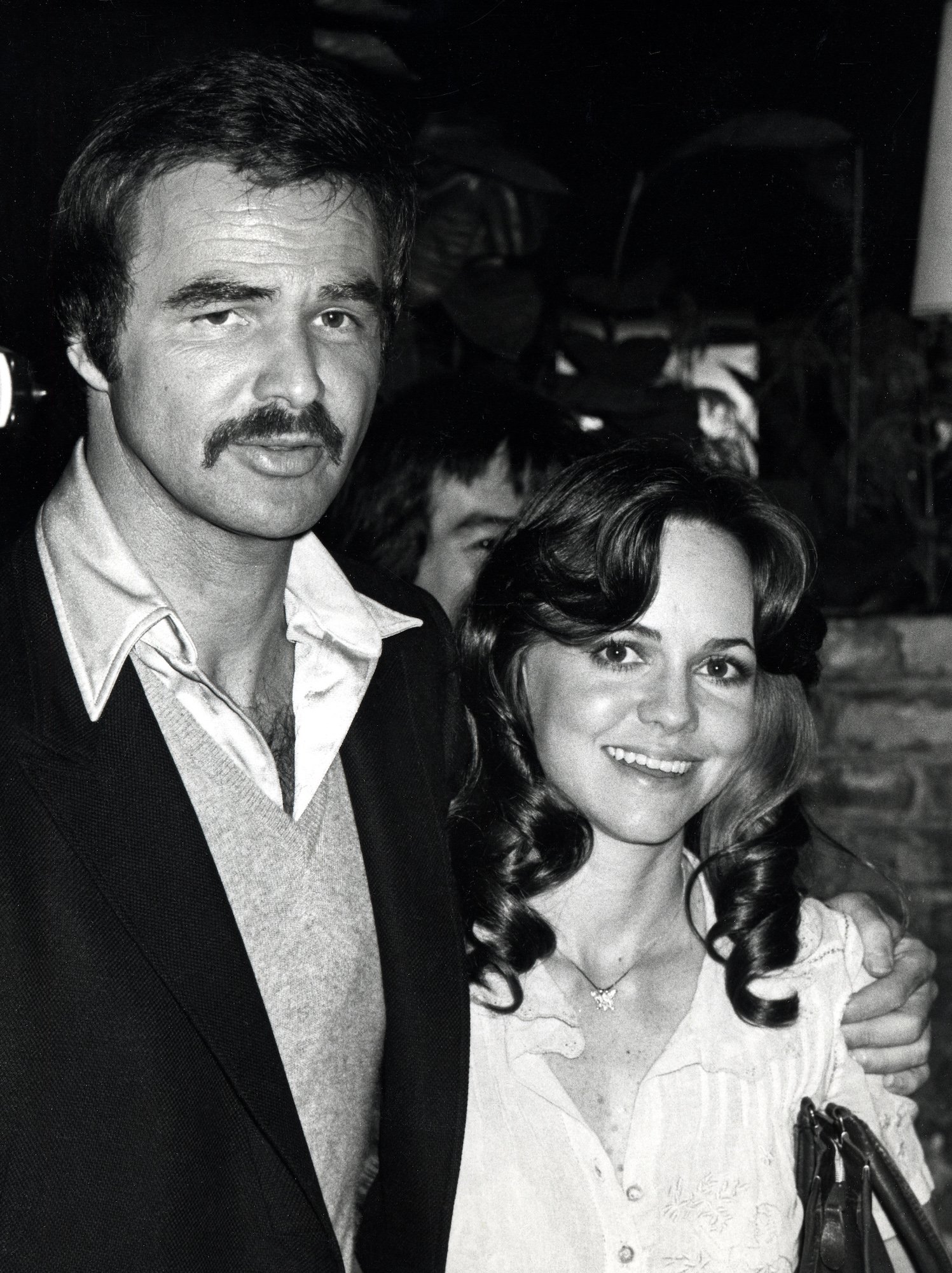 Burt Reynolds and Sally Field posing for a photo at a restaurant in Los Angeles
