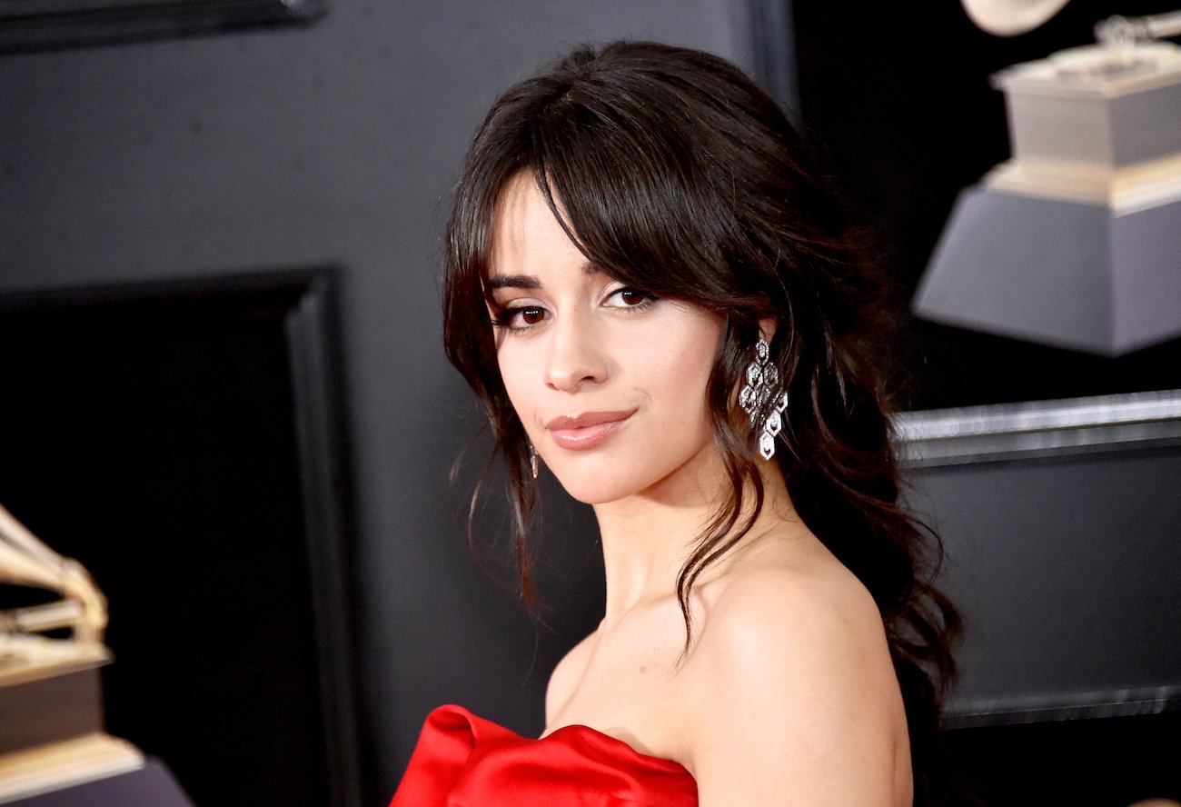 Camila Cabello looking on in front of black background
