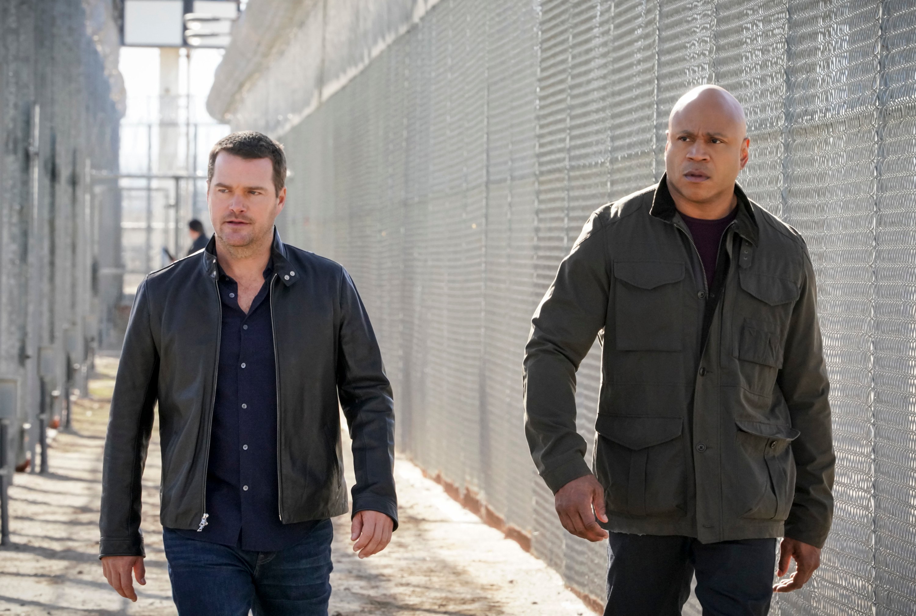 Actors Chris O'Donnell and LL Cool J walk side-by-side along a fence in a scene from 'NCIS: Los Angeles.'  