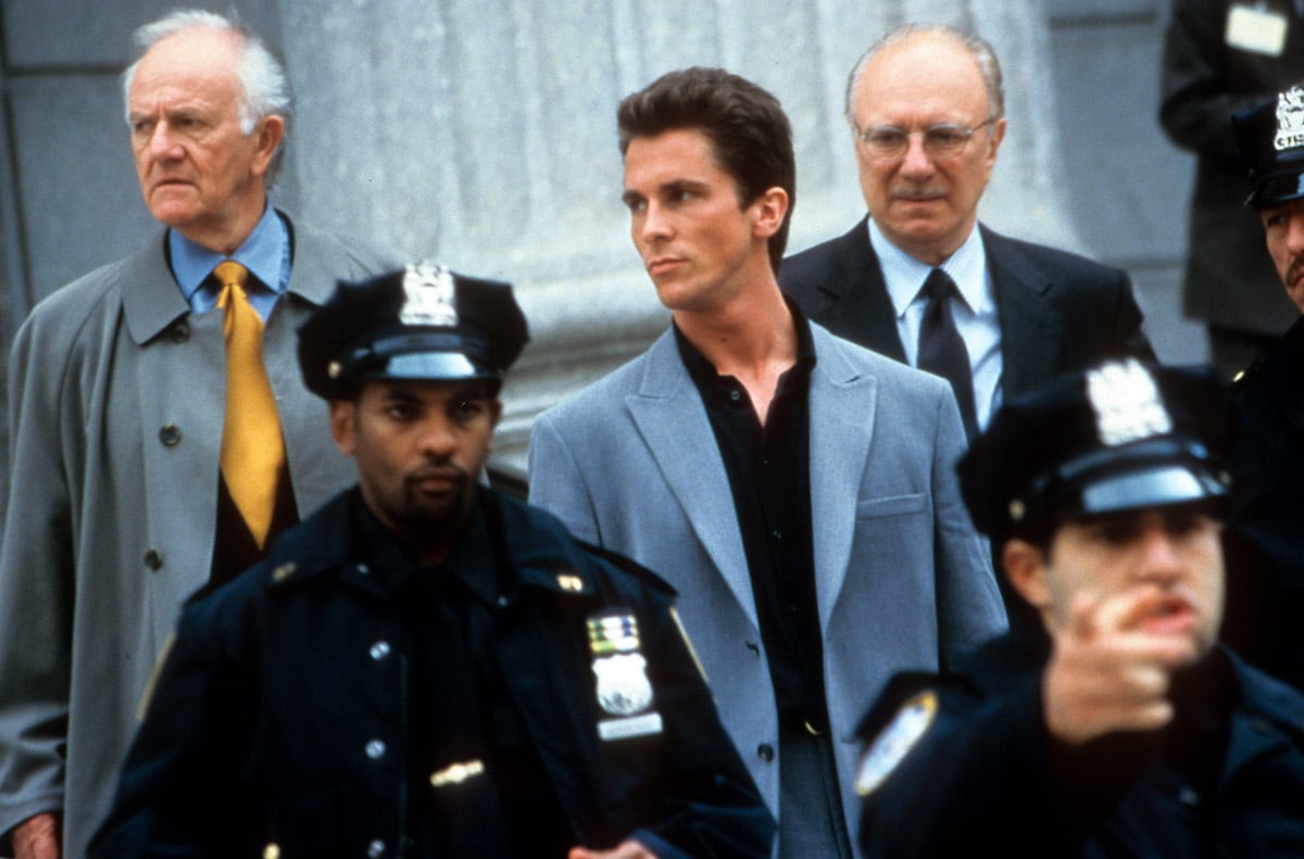 Christian Bale with officers in front of him in a scene from the 2000 film 'Shaft'