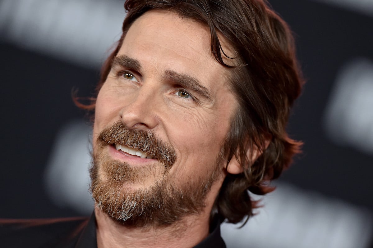 Christian Bale wears black and smiles at the ‘Ford v Ferrari’ premiere