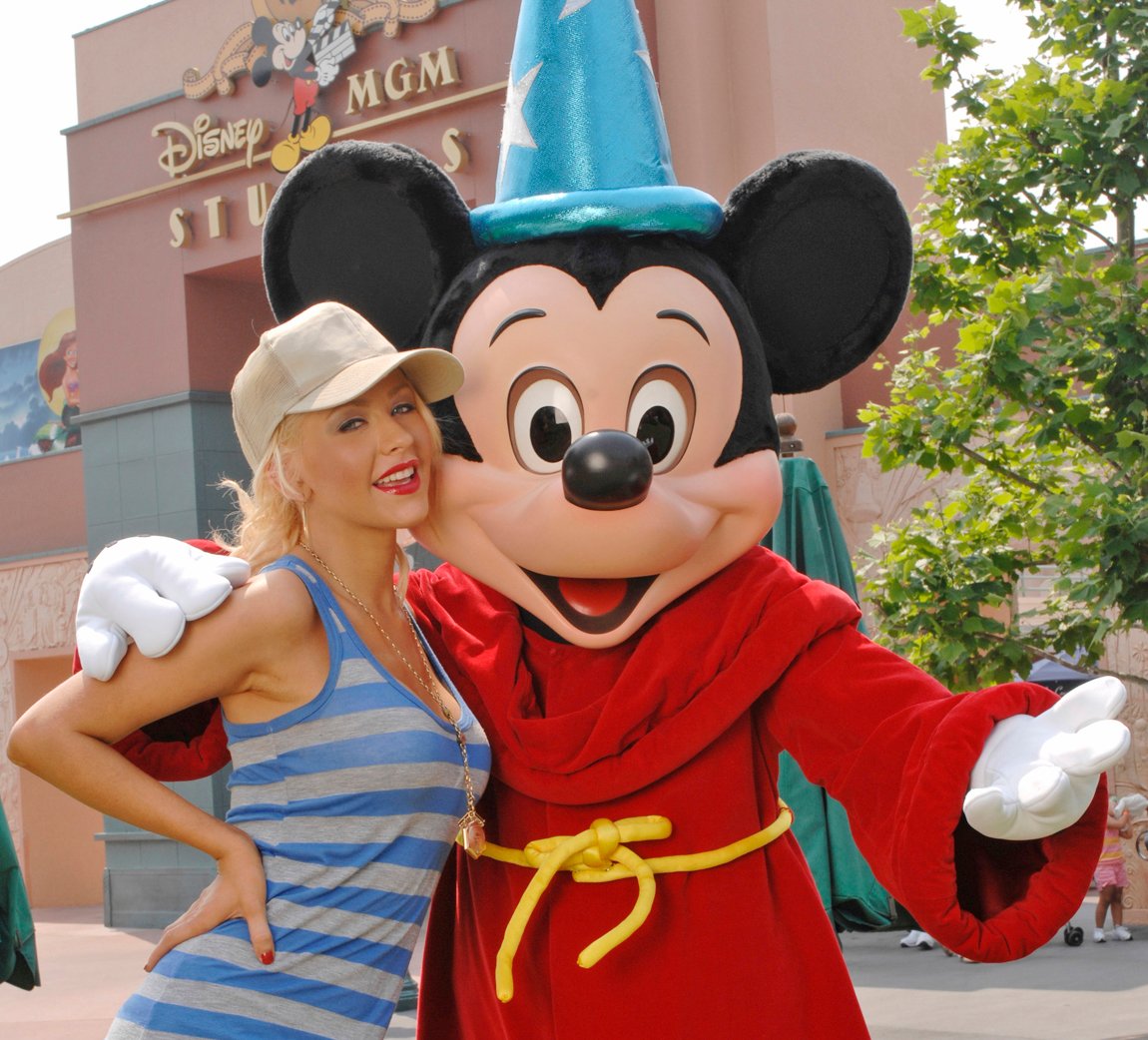Christina Aguilera poses with Mickey Mouse at the Disney MGM Studios