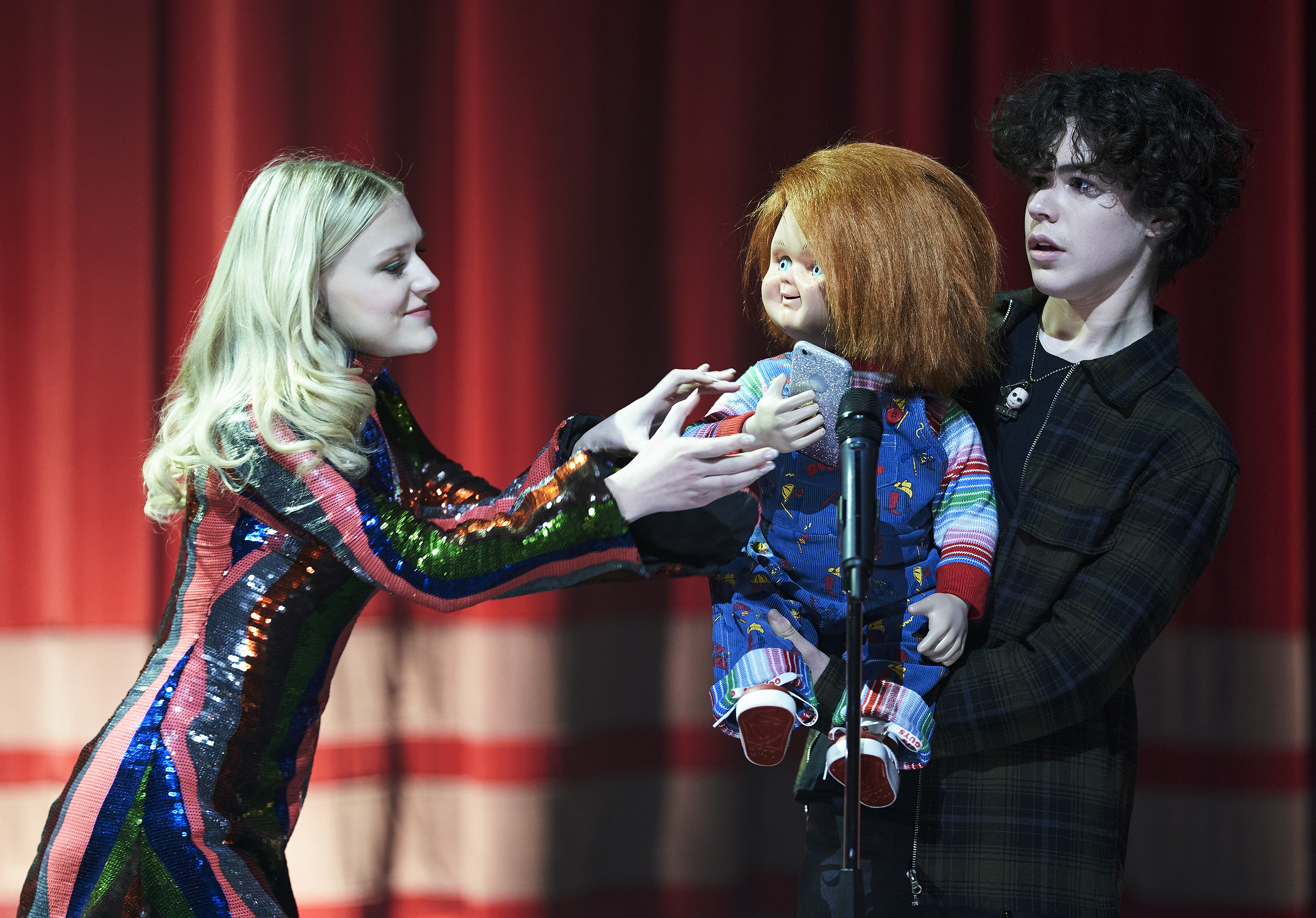 Chucky steals a cell phone at a talent show