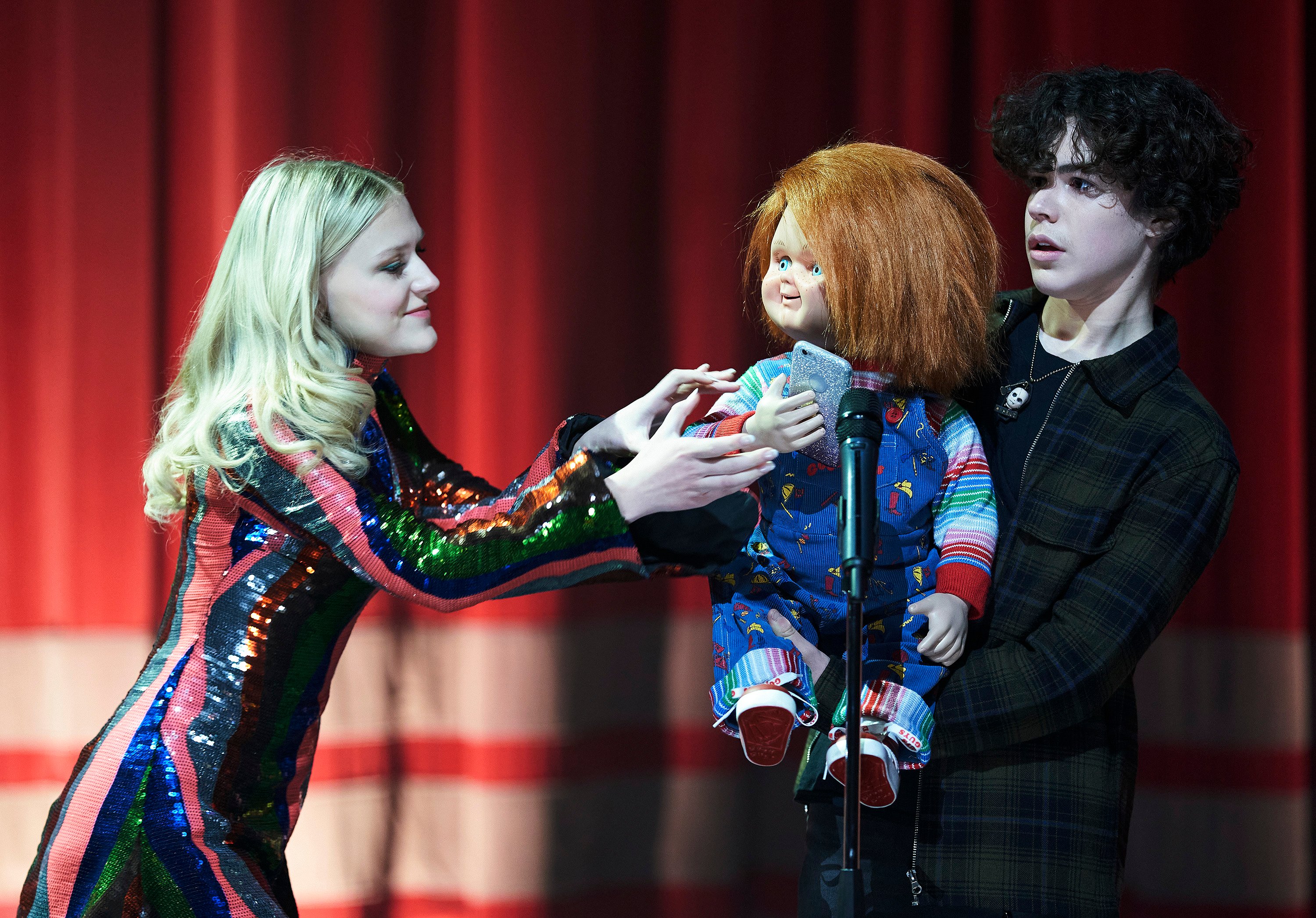 Chucky steals a cell phone at a talent show