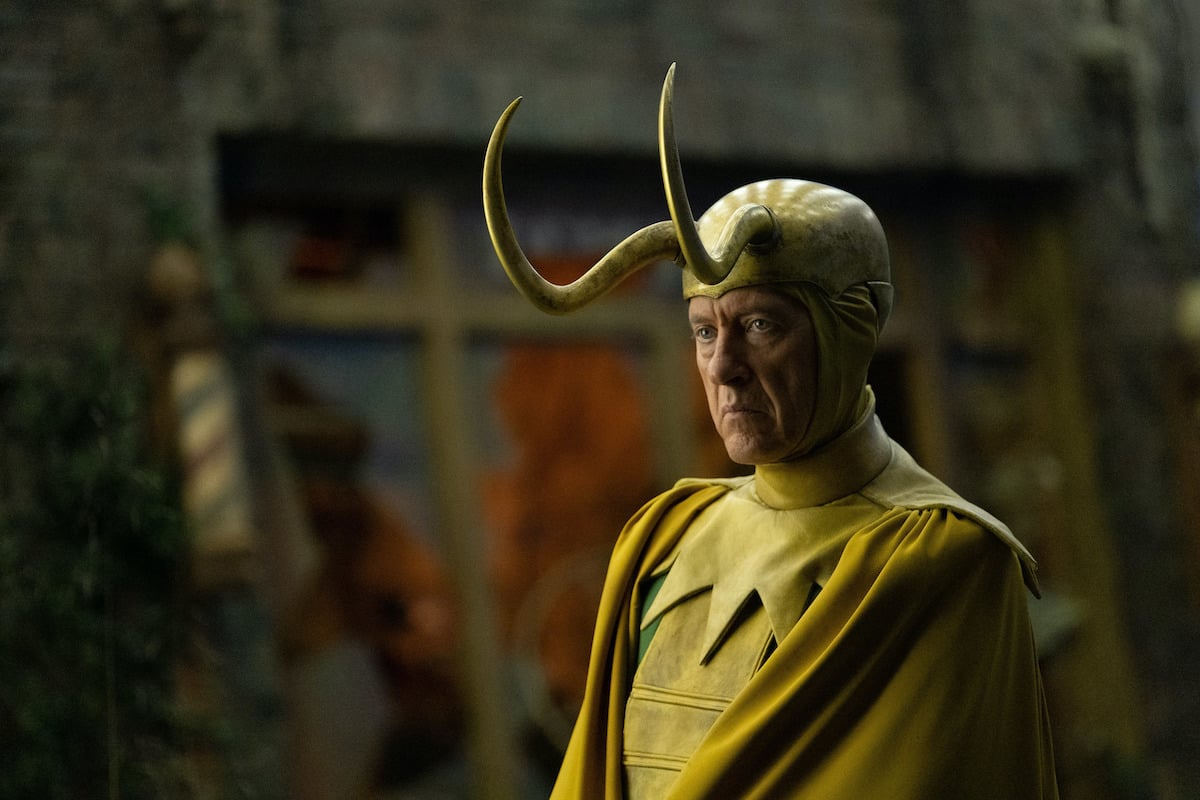 Richard E. Grant as Classic Loki in 'Loki' Episode 5. He wears a gold Loki helmet with long horns, a yellow cape and collar, and green suit. At the end of the episode, Classic Loki dies to help Loki and Sylvie enchant Alioth. But some fans think Classic Loki faked his death and actually survived.