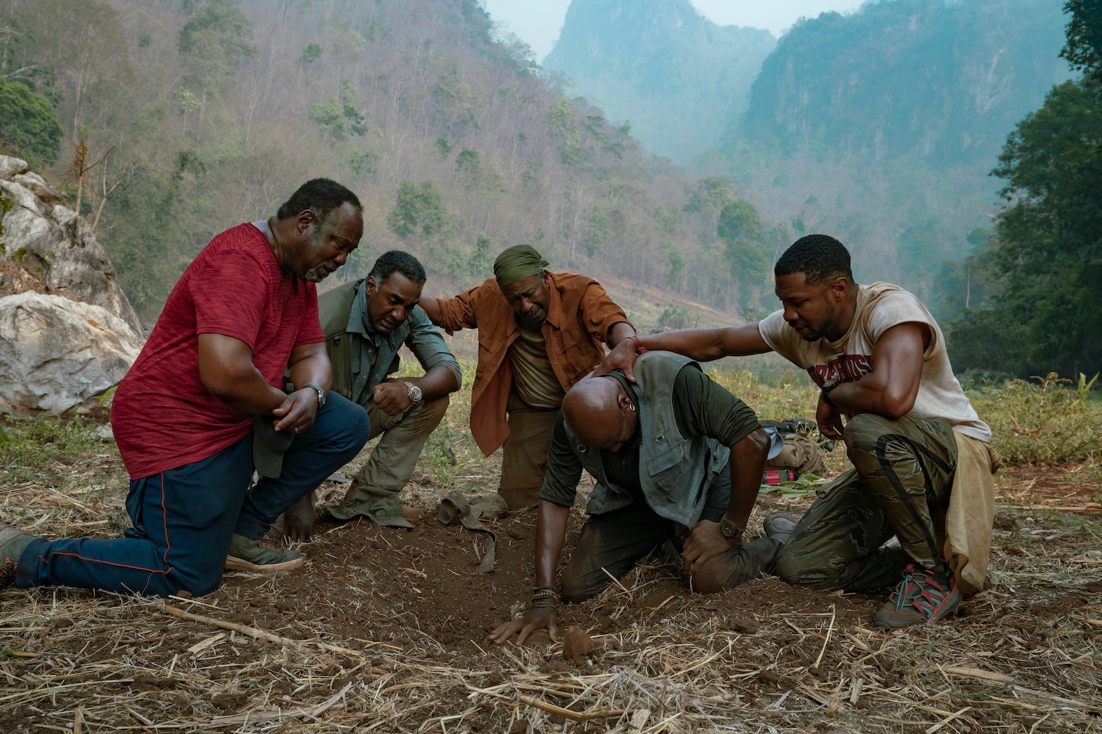 Five actors kneeling on the ground in a circle in 'Da 5 Bloods,' one of the best war movies on Netflix