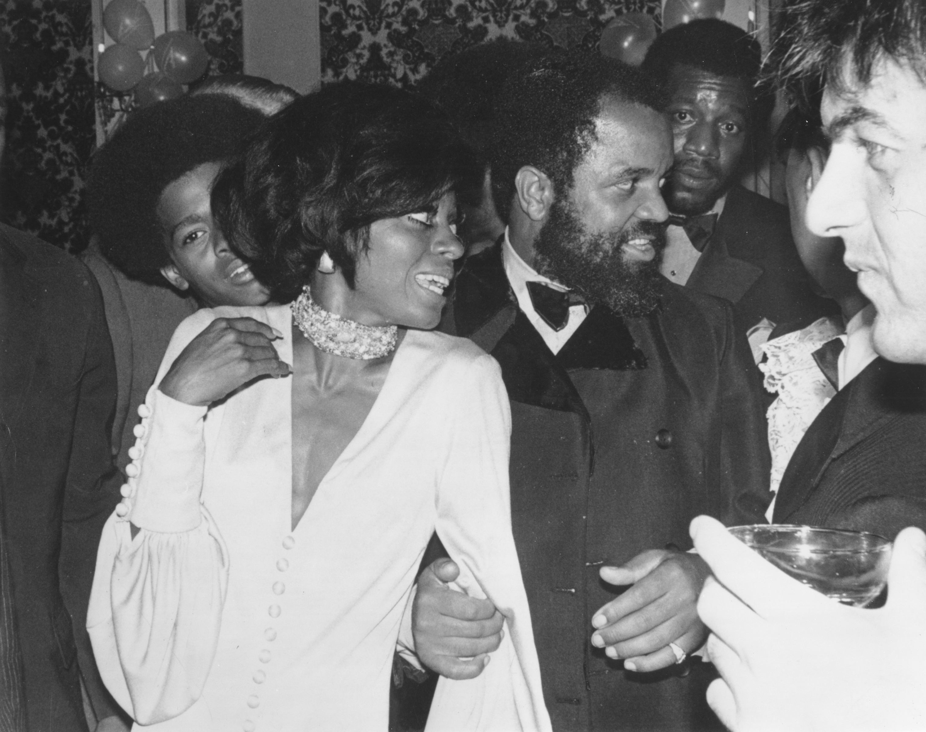 Diana Ross and Berry Gordy attending an event together and looking away from the camera.