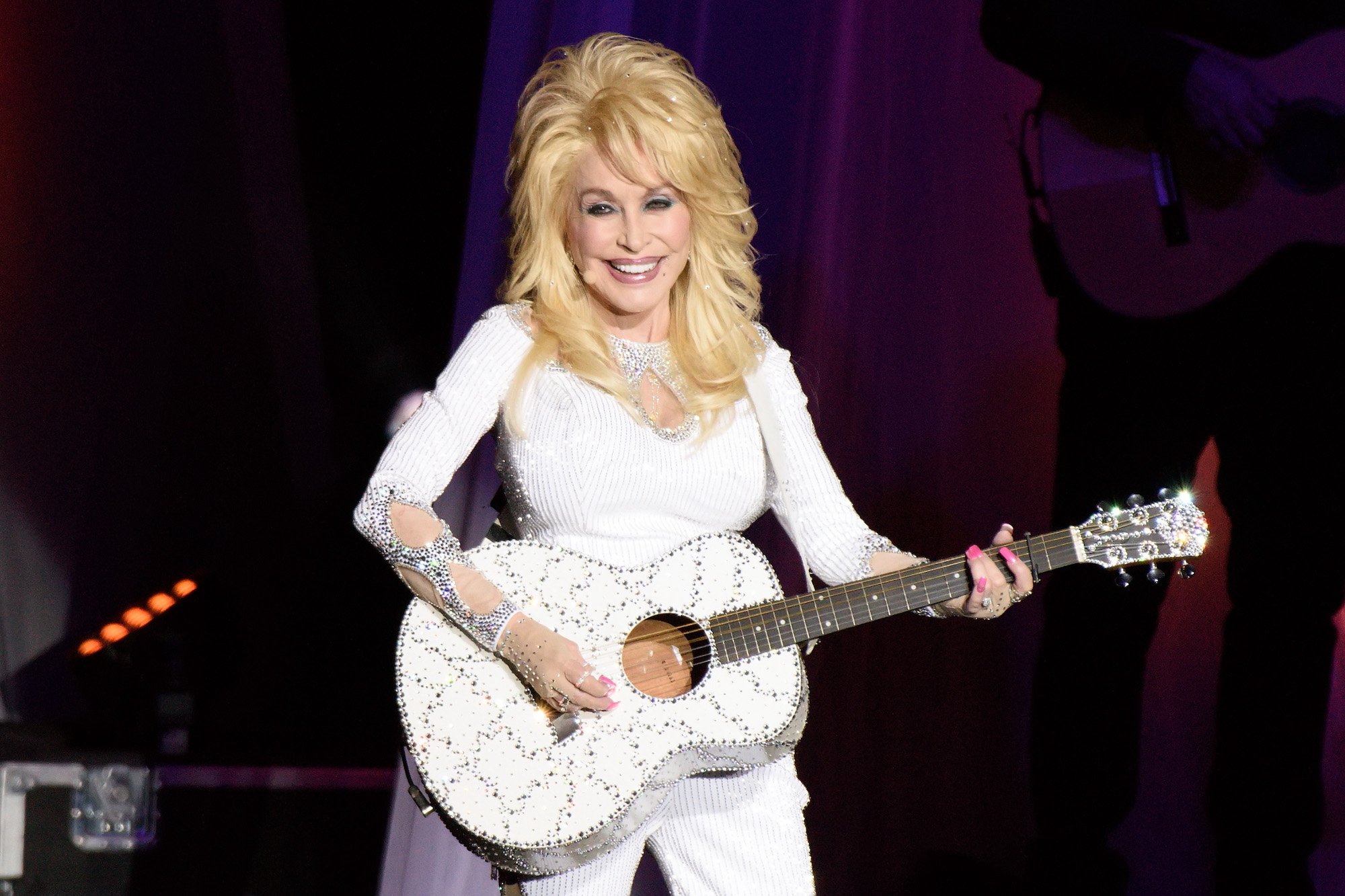 Dolly Parton performing onstage during the Pure & Simple Tour in 2016