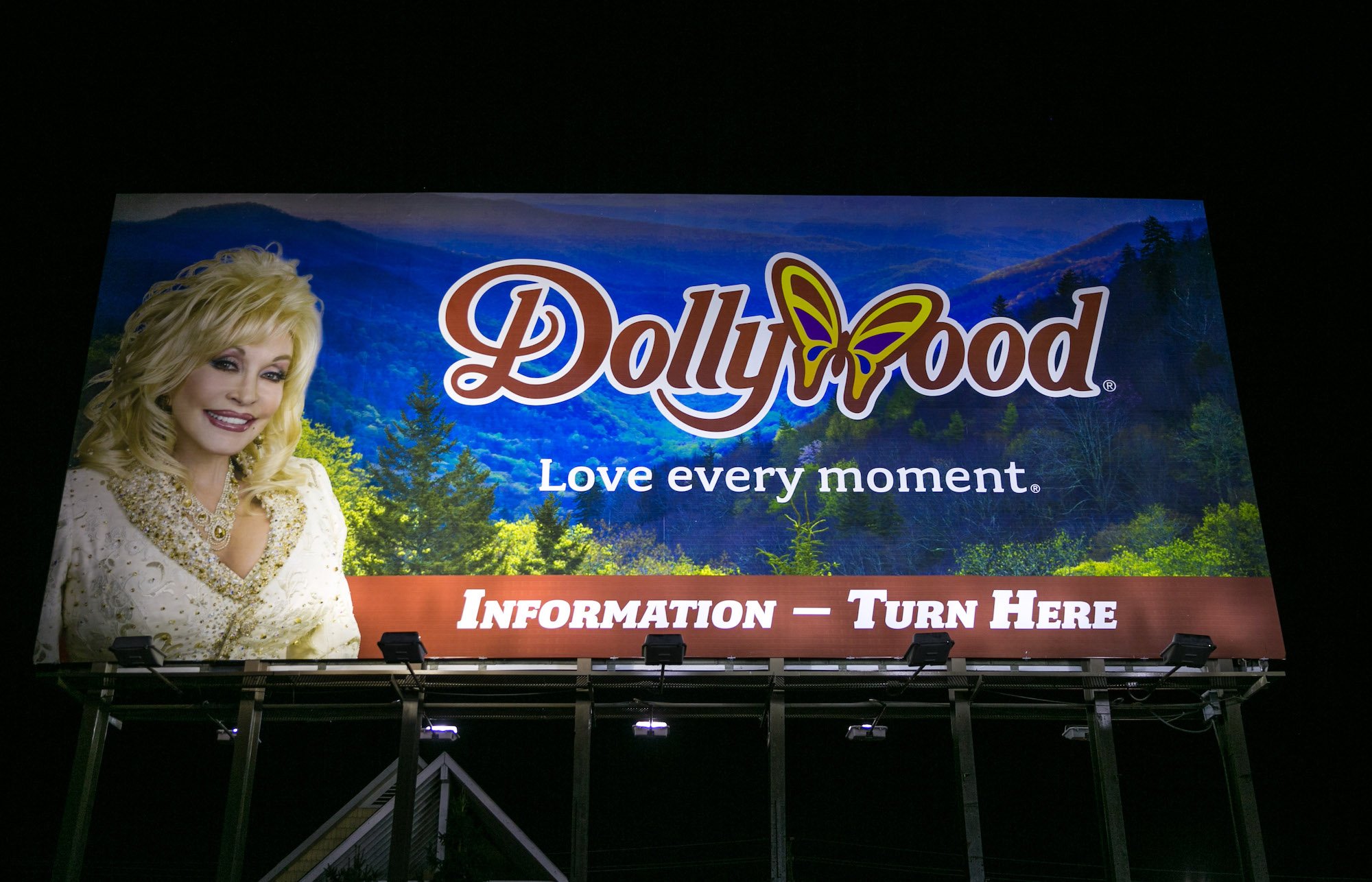 Dollywood billboard with a photo of Dolly Parton in the left corner