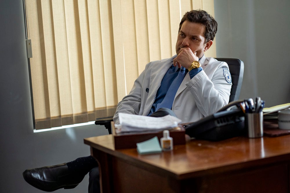 Joshua Jackson as Christopher Duntsch, wearing a lab coat, seated