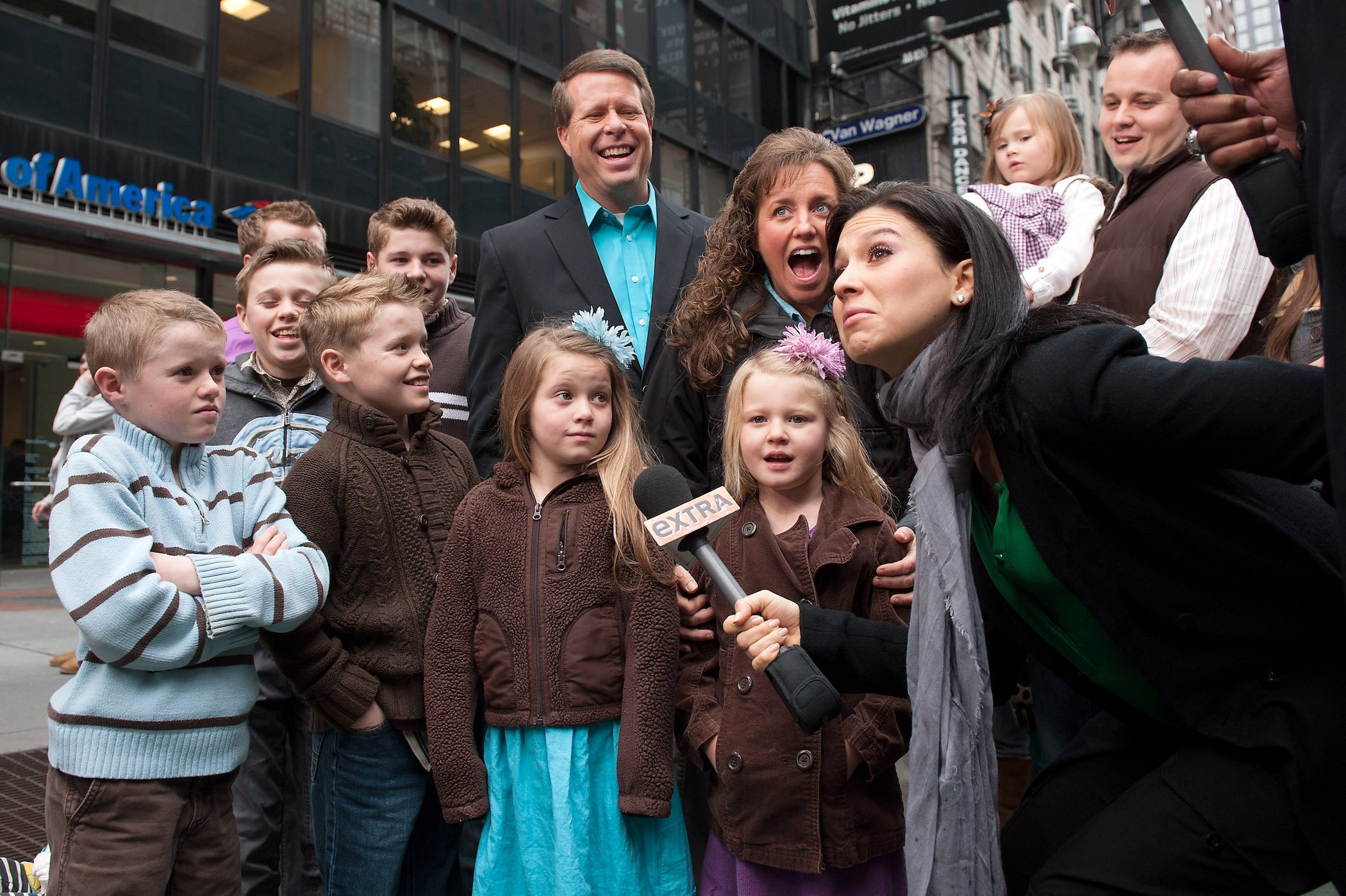 Hilaria Baldwin smiling with the Duggar family outdoors during their visit with 'Extra'