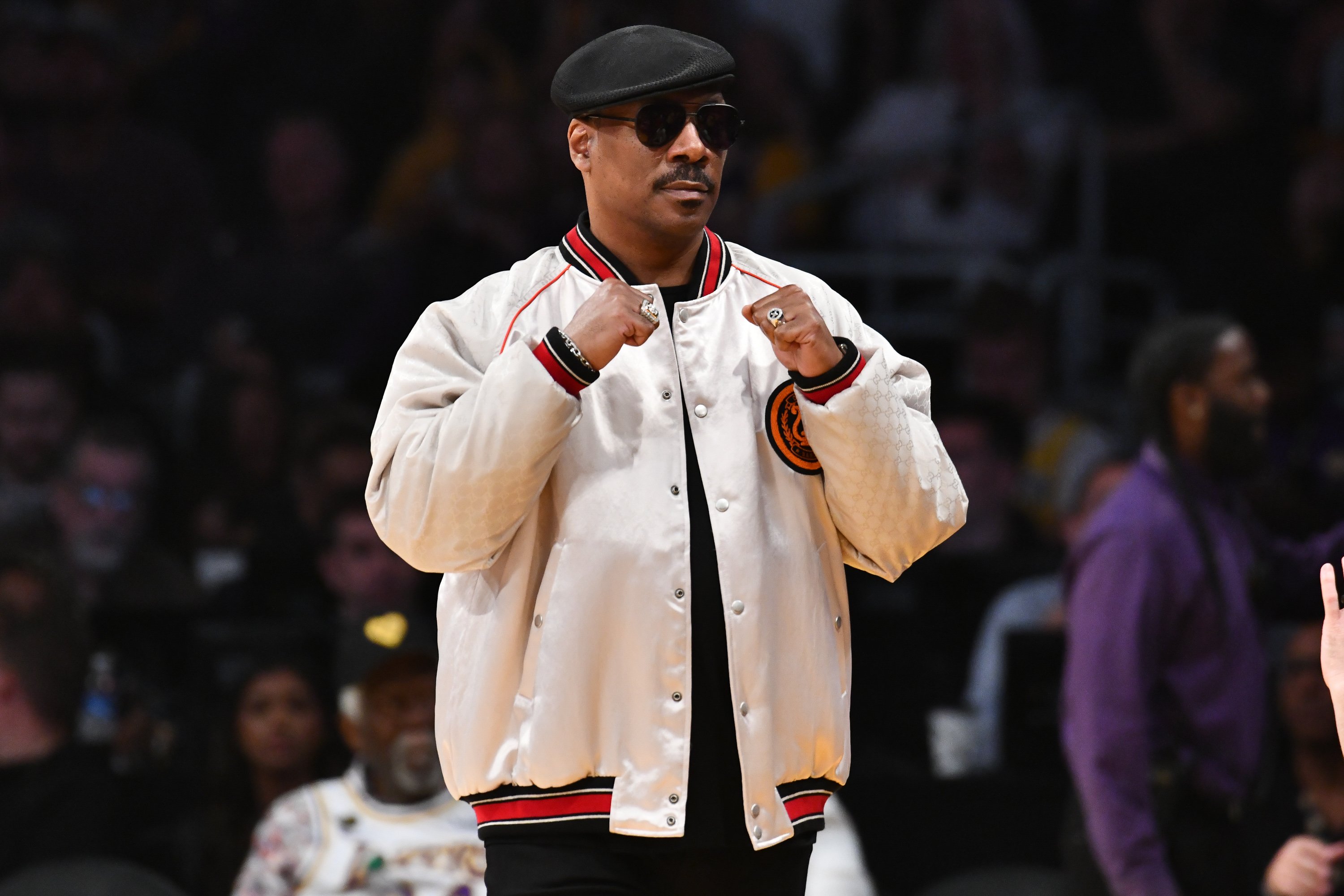 Eddie Murphy raises his fists at a LA Lakers game