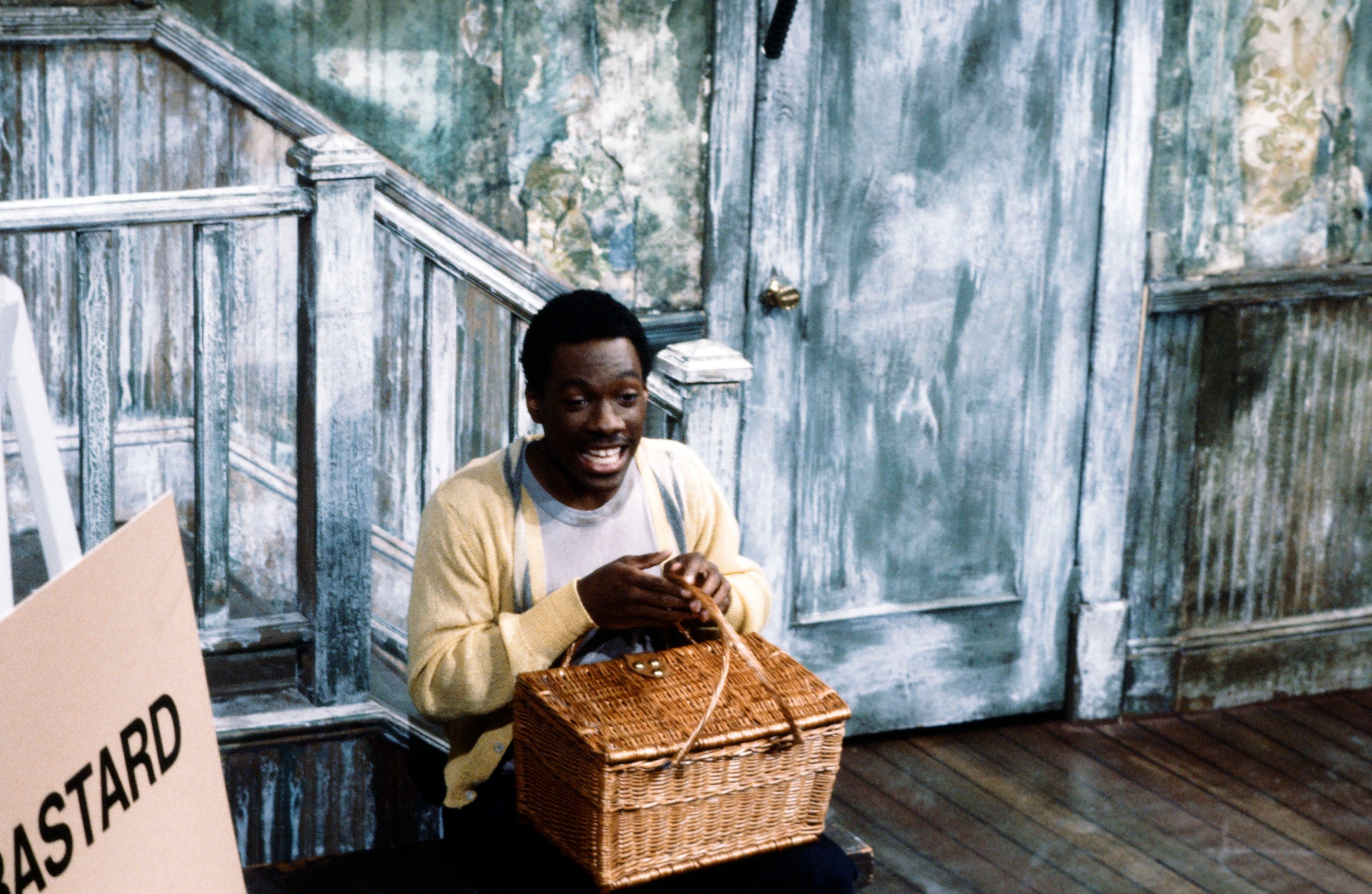 Eddie Murphy sits on the Mr. Robinson's Neighborhood set