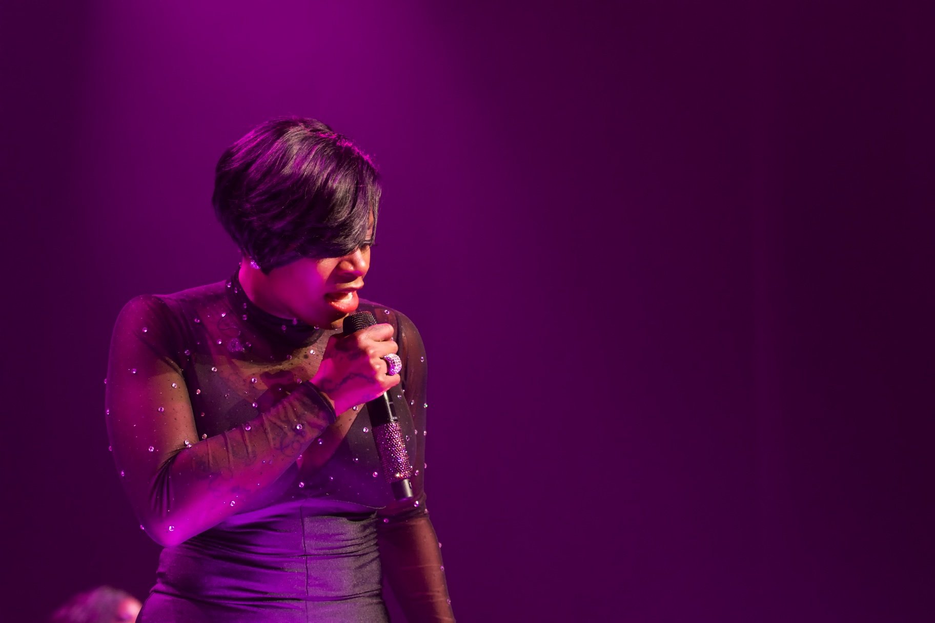 Fantasia singing into a mic