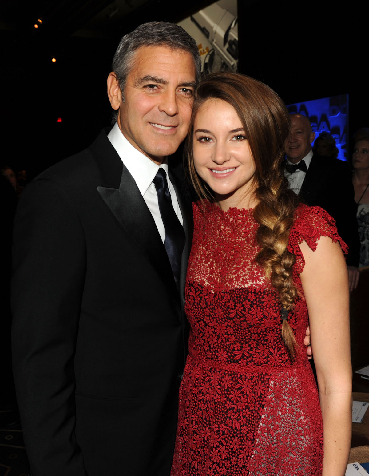 George Clooney and Shailene Woodley smile as they pose for a photo at the 2012 Directors Guild of America Awards cocktail reception