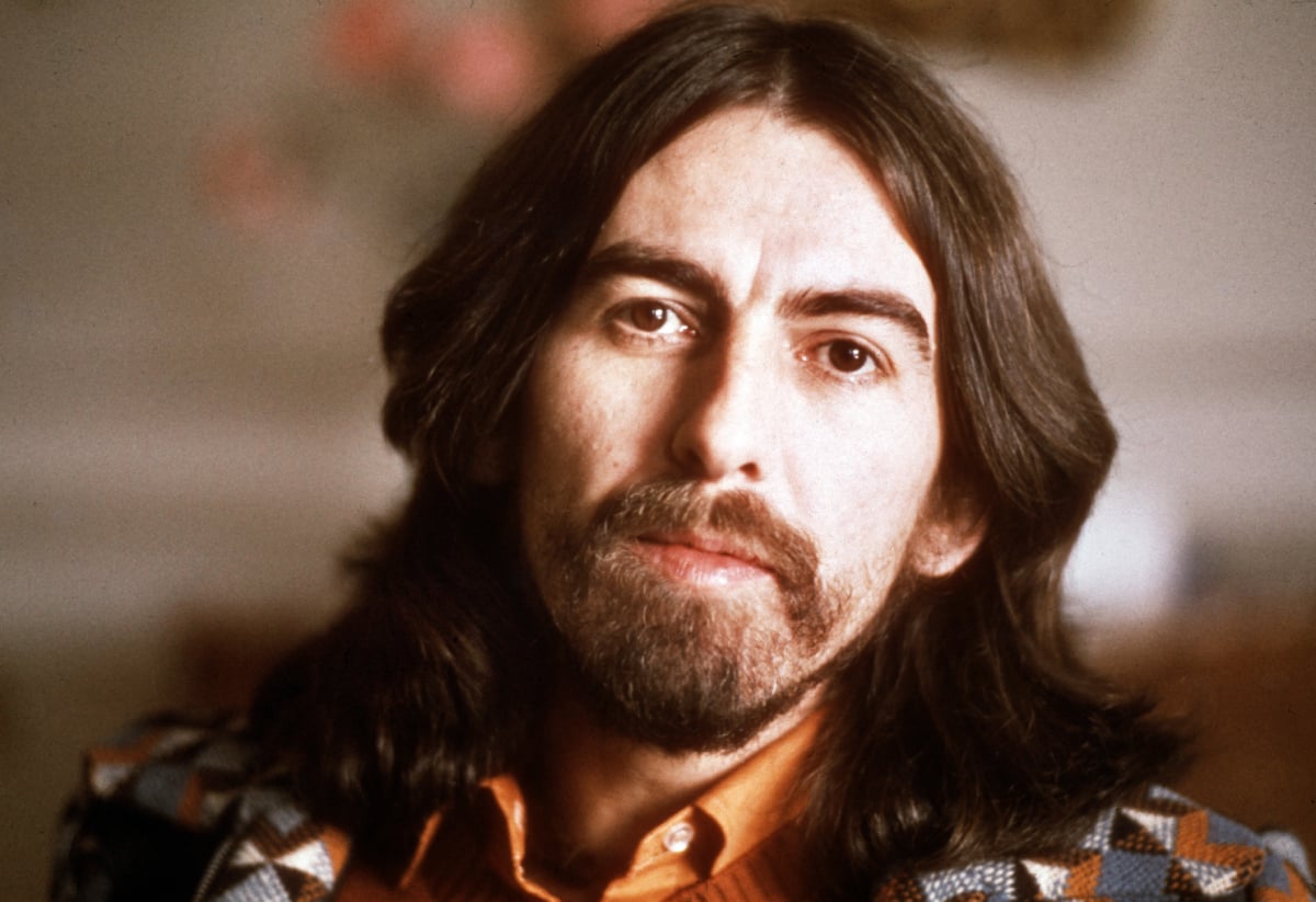 Former Beatle George Harrison faces the camera in a 1976 portrait sporting shoulder-length hair as well as a beard.