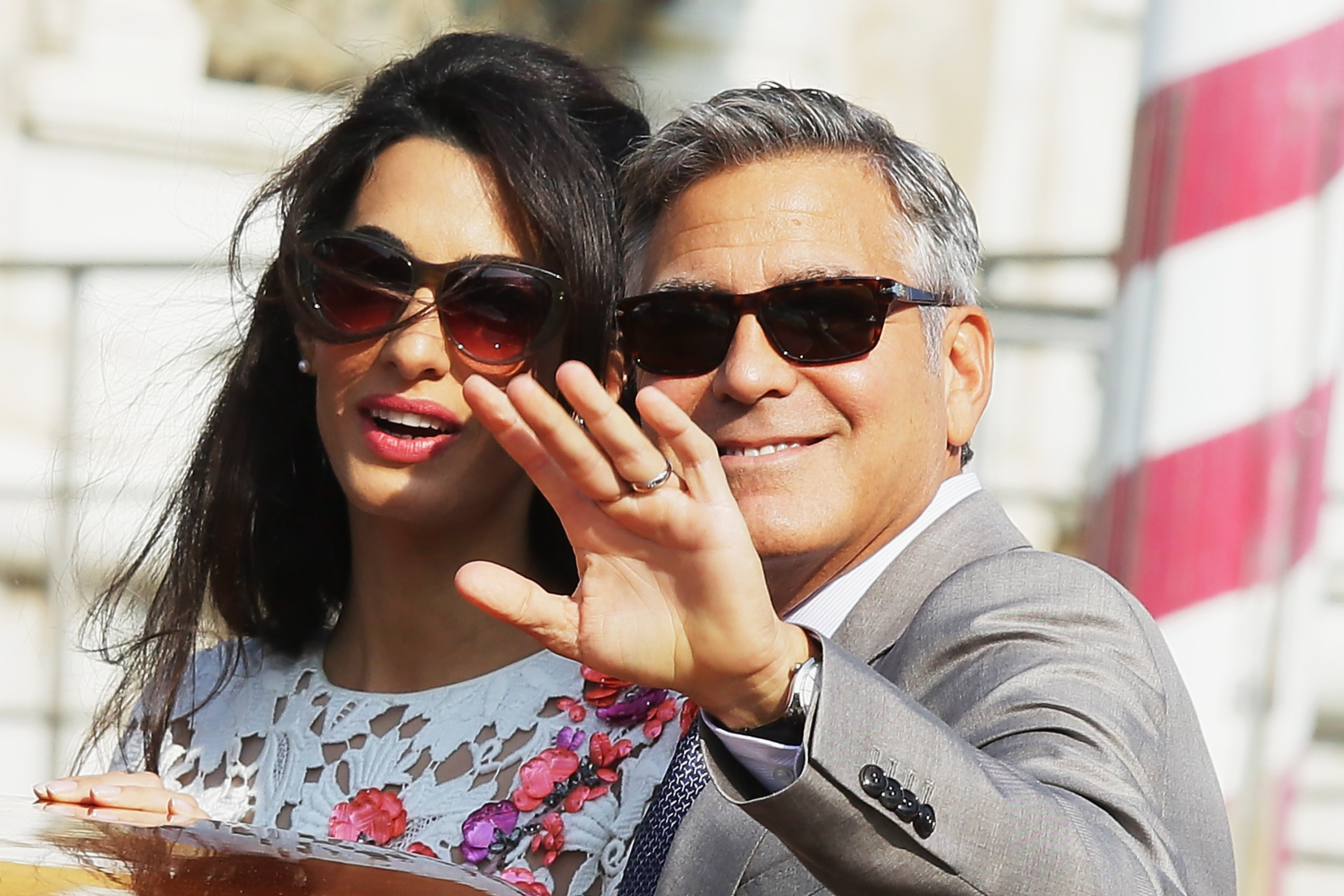 George Clooney and Amal Alamuddin Clooney smiling and wearing sunglasses in Venice