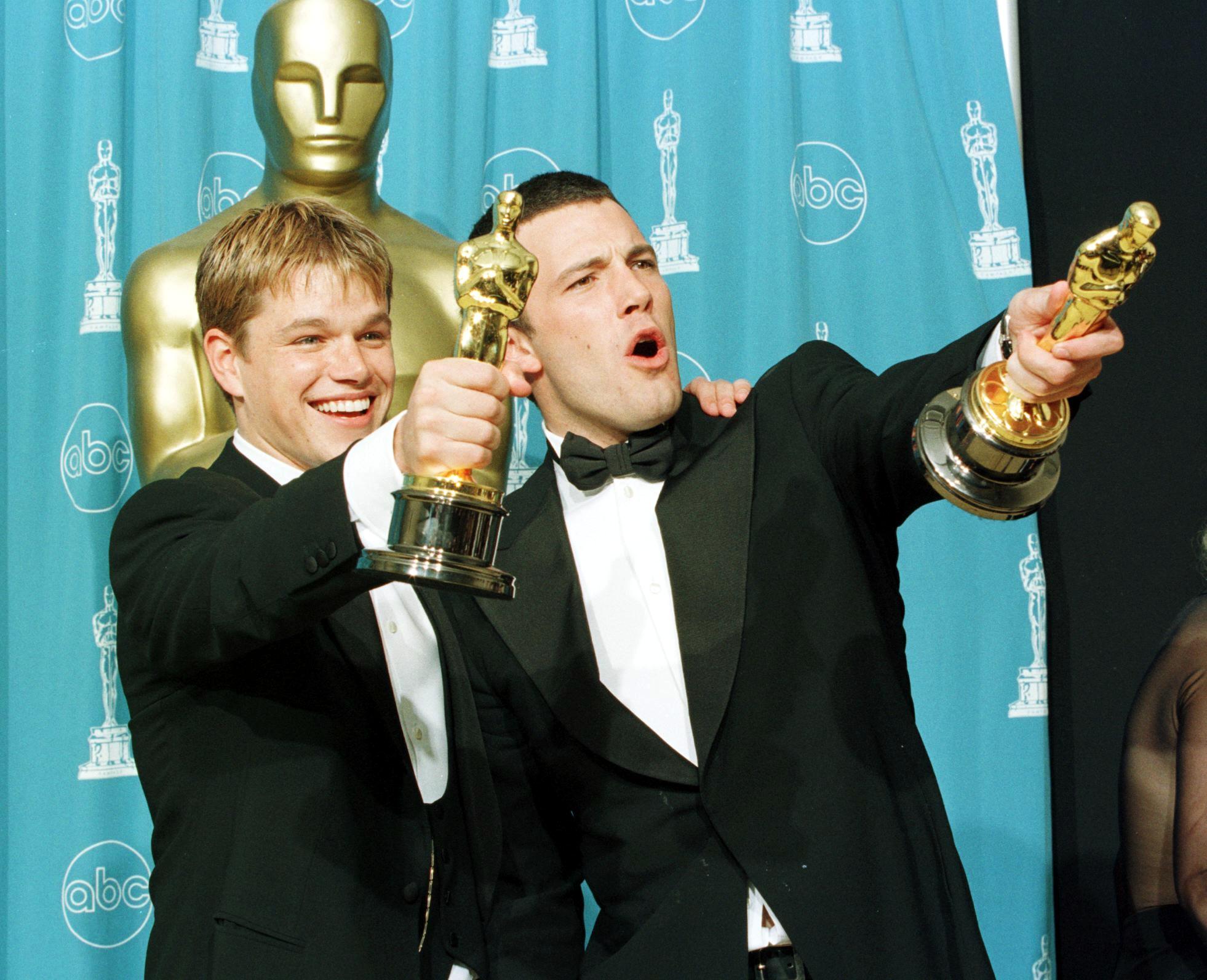 Good Will Hunting winners Matt Damon and Ben Affleck point their Oscars