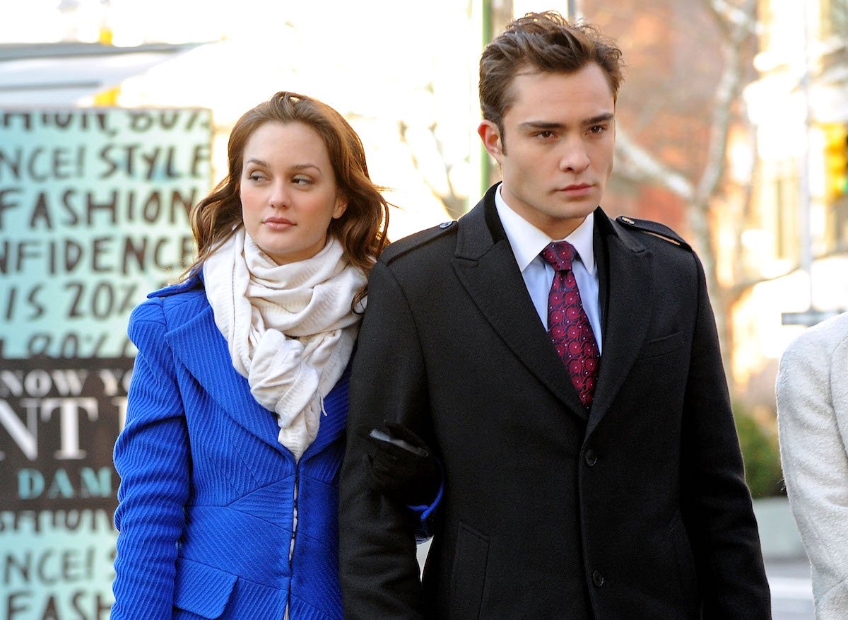 Leighton Meester as Blair Waldorf and Ed Westwick as Chuck Bass stand next to each other on a New York street in 'Gossip Girl'