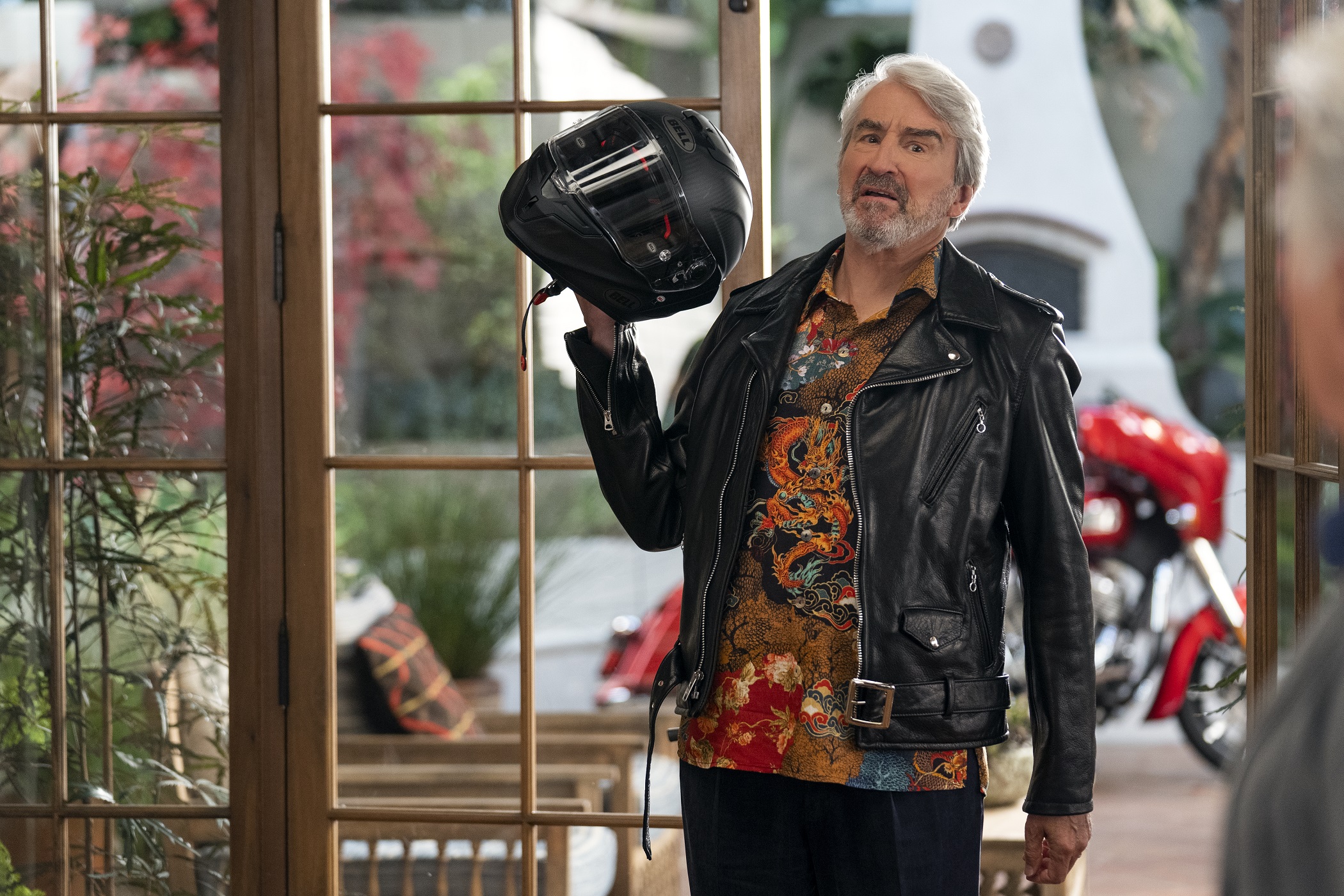 Sol Bergstein holds a motorcylce helmet after a large, impulse purchase in season 6 of 'Grace and Frankie'