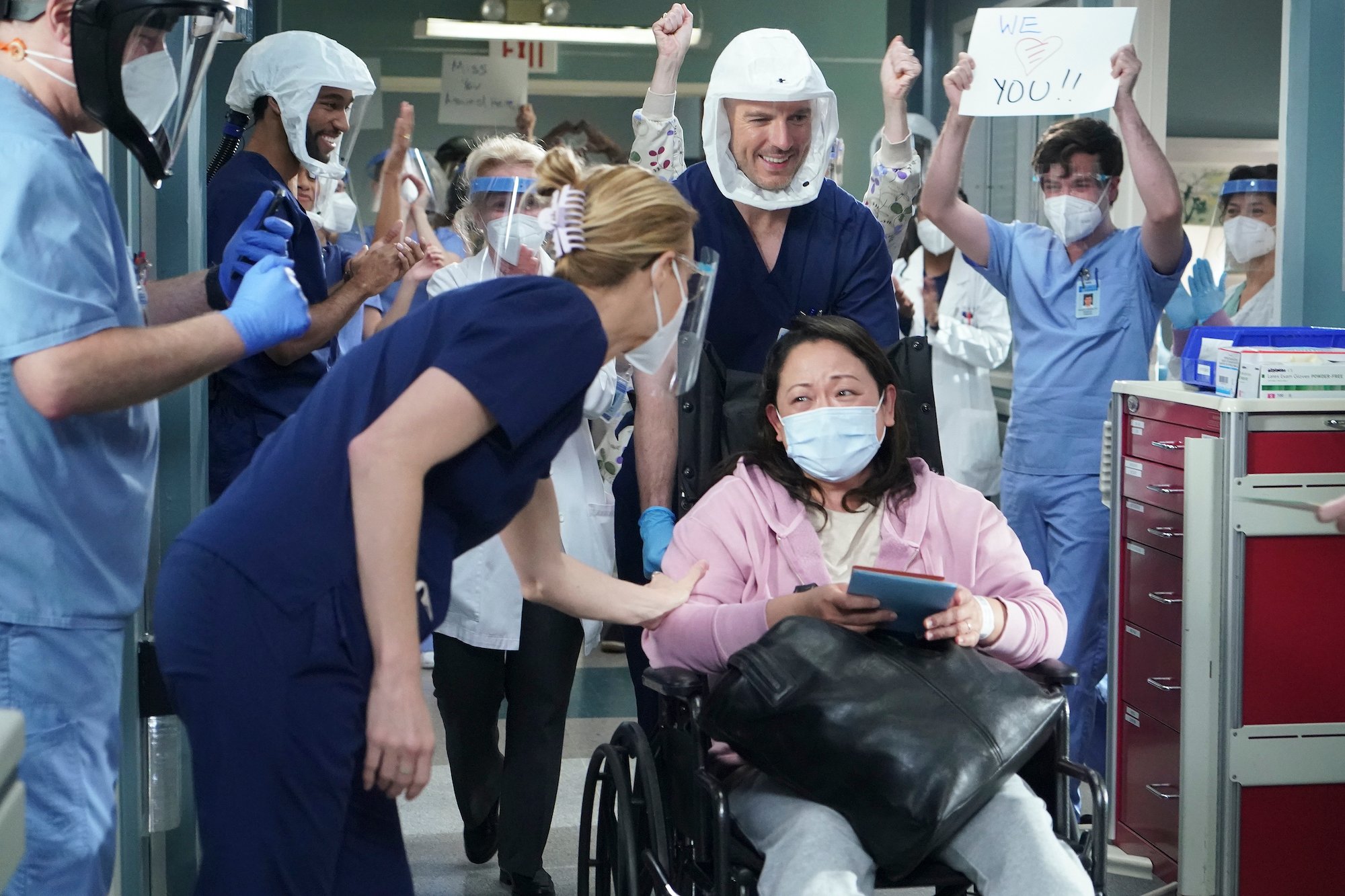 Grey's Anatomy cast wheeling out a patient and cheering