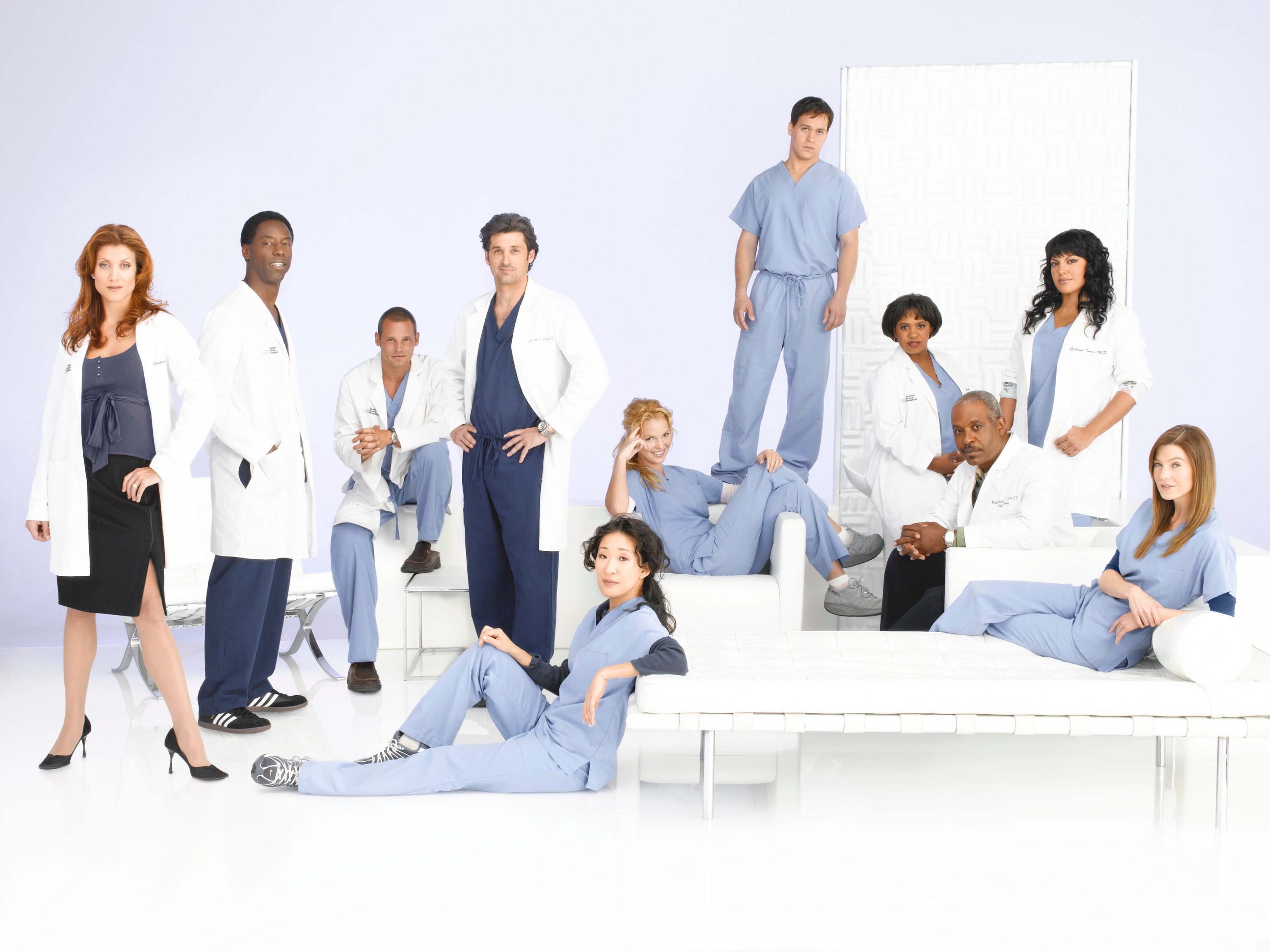 'Grey's Anatomy' cast members smile and pose for the camera in their medical scrubs for a promotional photo