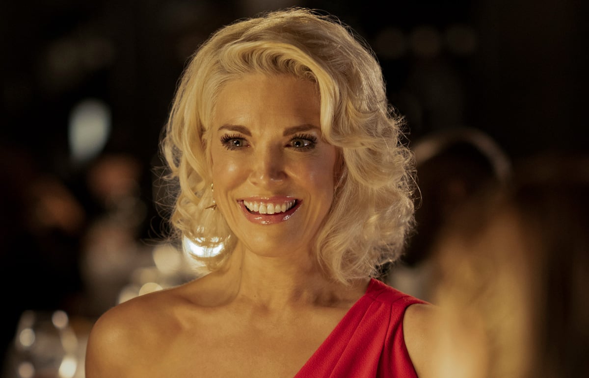 Hannah Waddingham smiles wearing a red dress as Rebecca Welton on 'Ted Lasso'