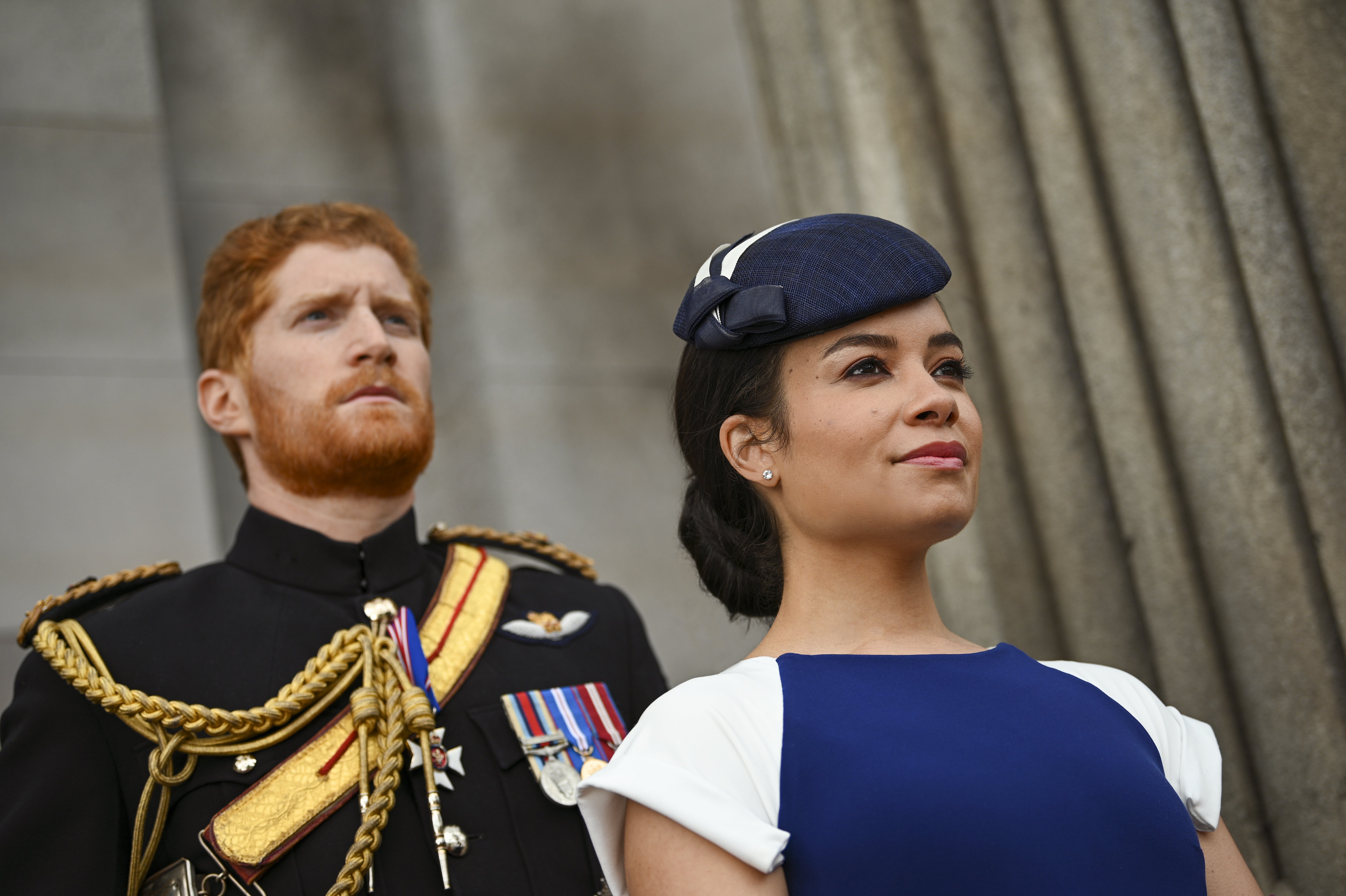 Harry, in uniform, and Meghan, in a blue hat, in 'Harry & Megan: Escaping the Palace'