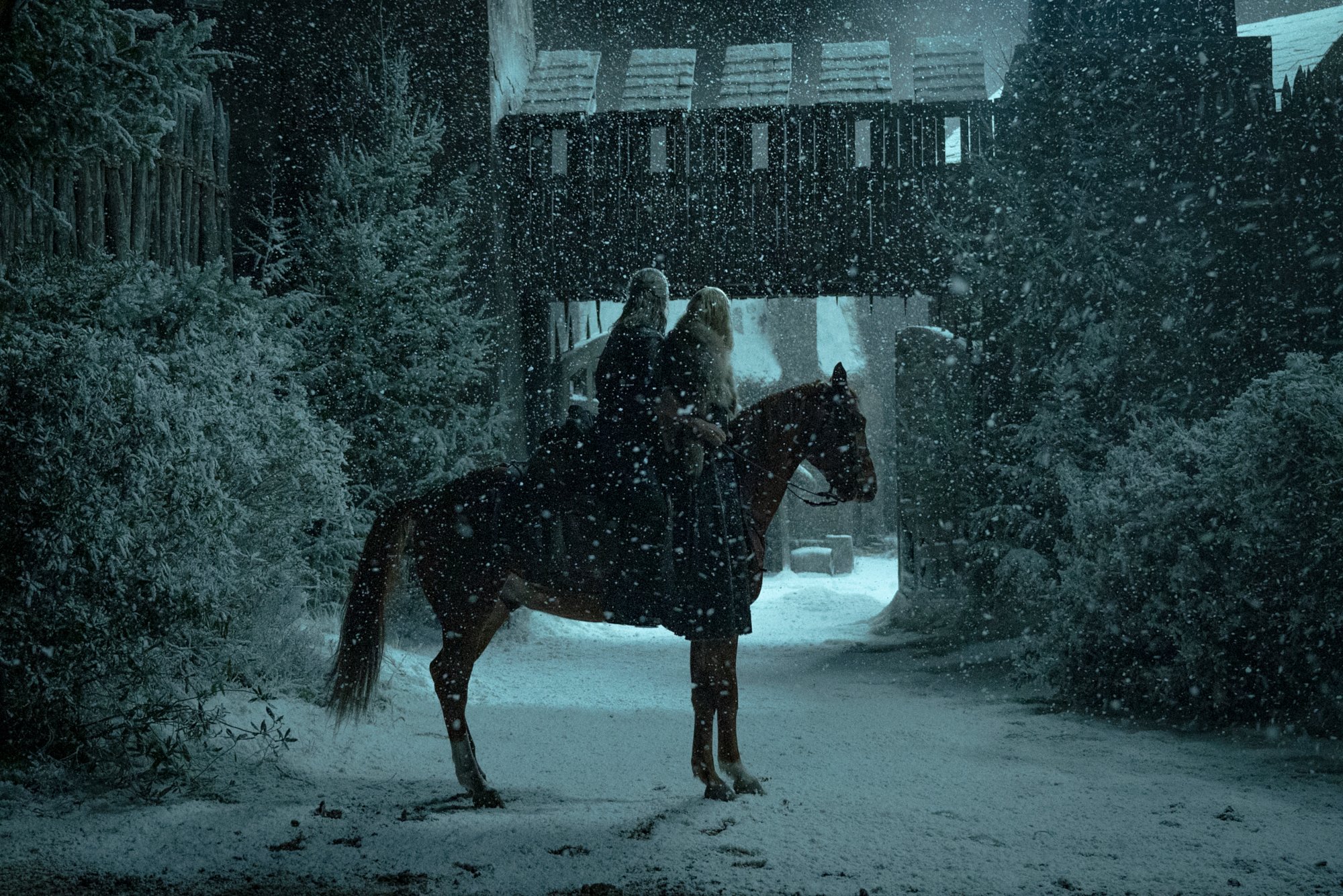 Henry Cavill as Geralt and Freya Allen as Princess Cirilla ride a horse in the snow during The Witcher Season 2