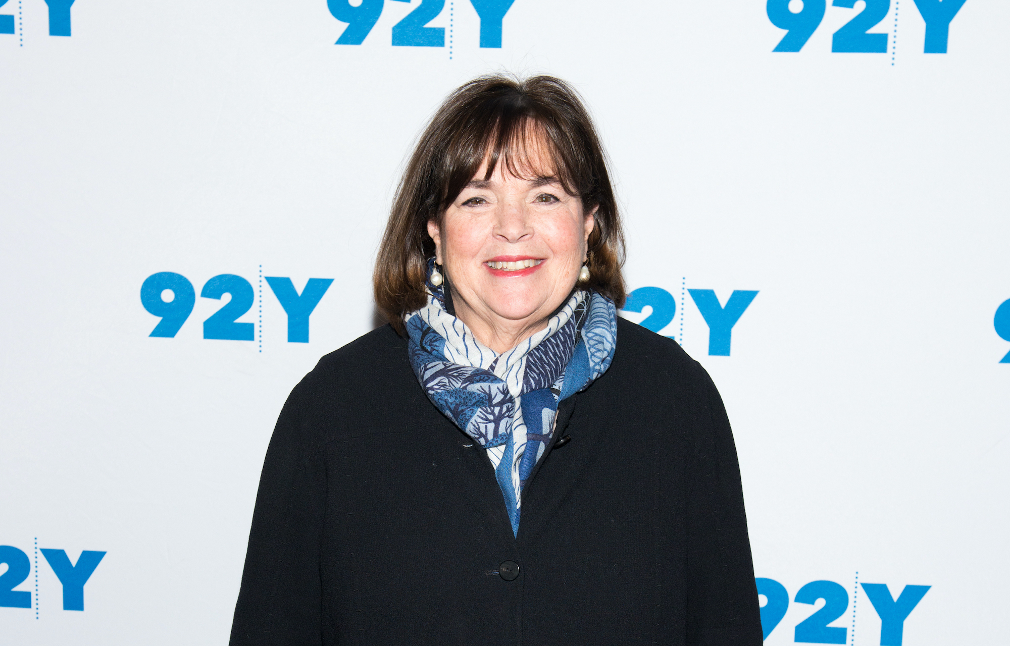 Ina Garten smiling in front of a white background
