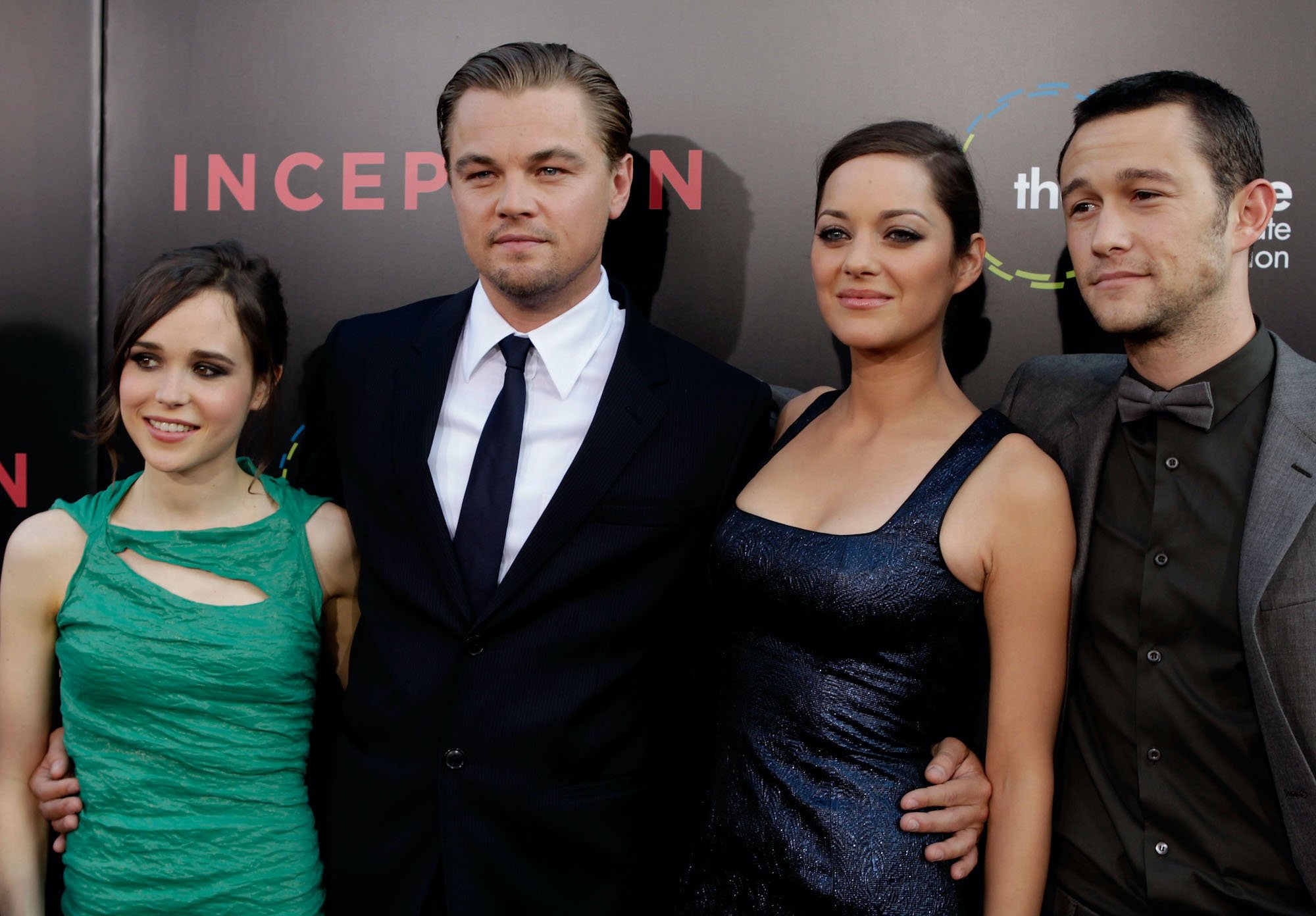 'Inception' cast smiling in front of a black background