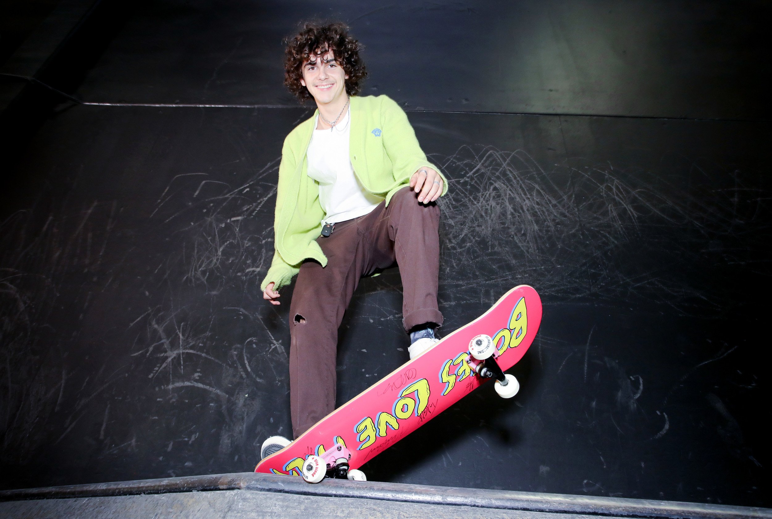 Jack Dylan Grazer, who voices Alfredo in Pixar's 'Luca,' posing on a red skateboard