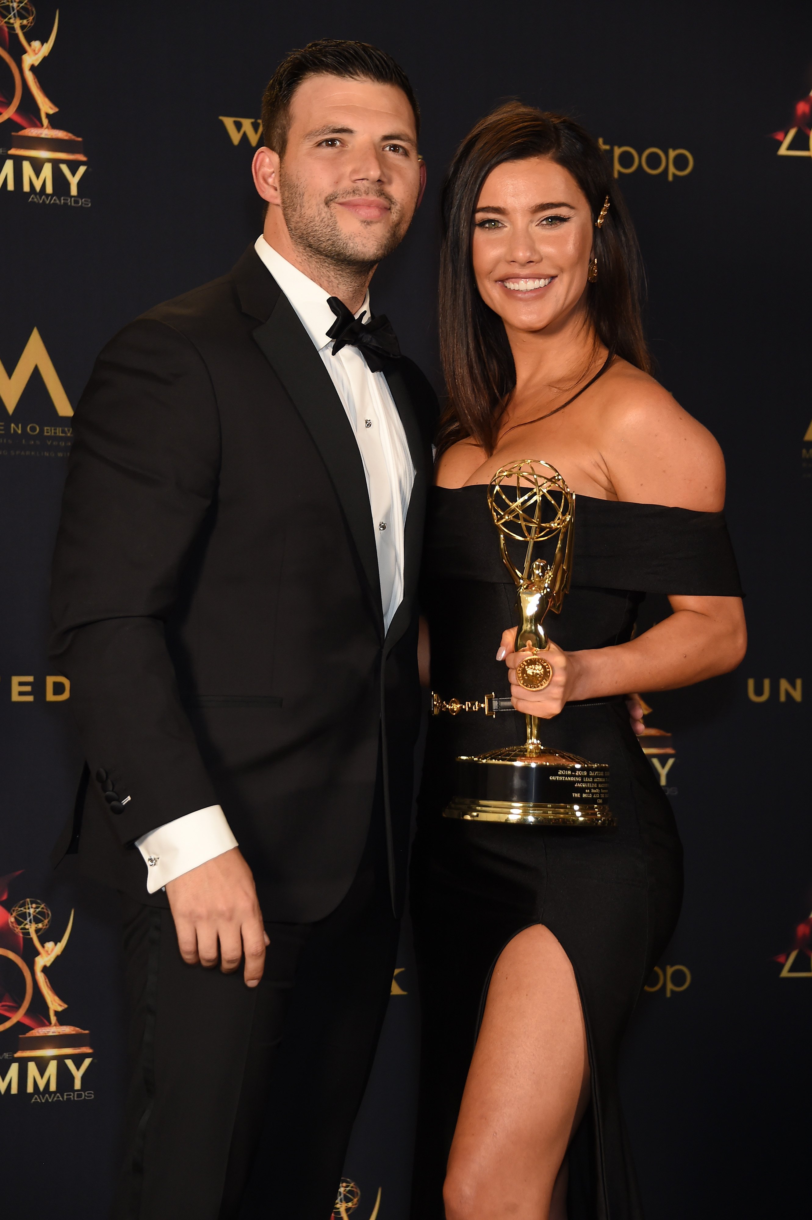 Jacqueline MacInnes Wood and her husband, Elan Ruspol, smile for photo in press room the 46th annual Daytime Emmy Awards