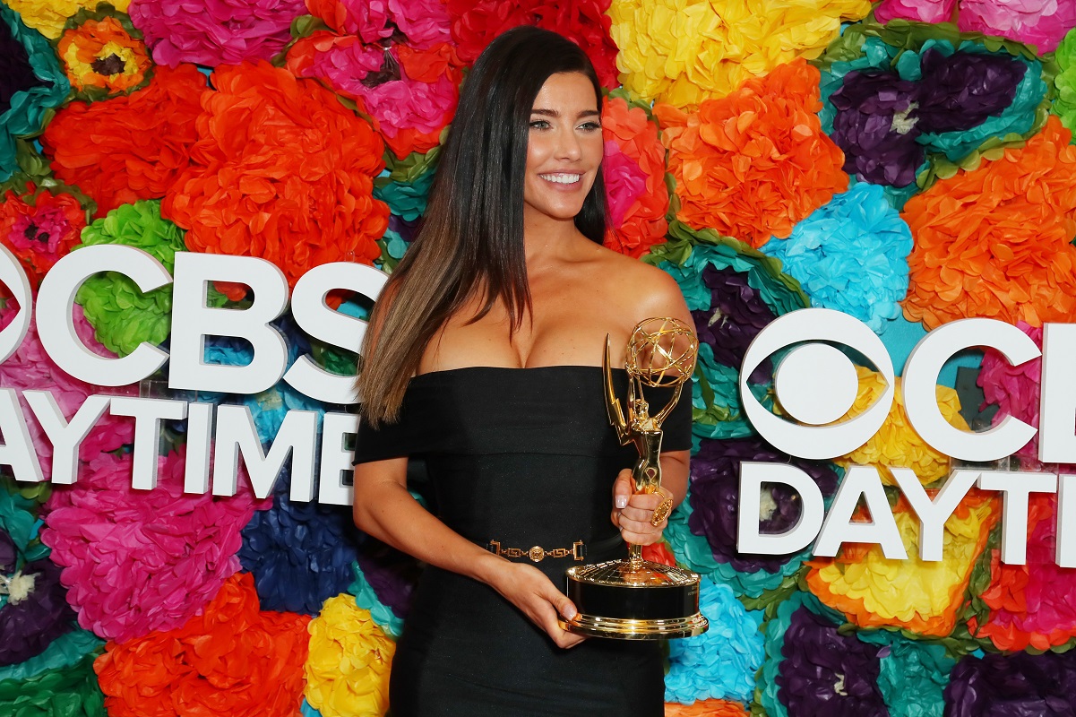 Jacqueline MacInnes Wood wearing a black dress and posing with her Daytime Emmy Award at Emmy afterparty