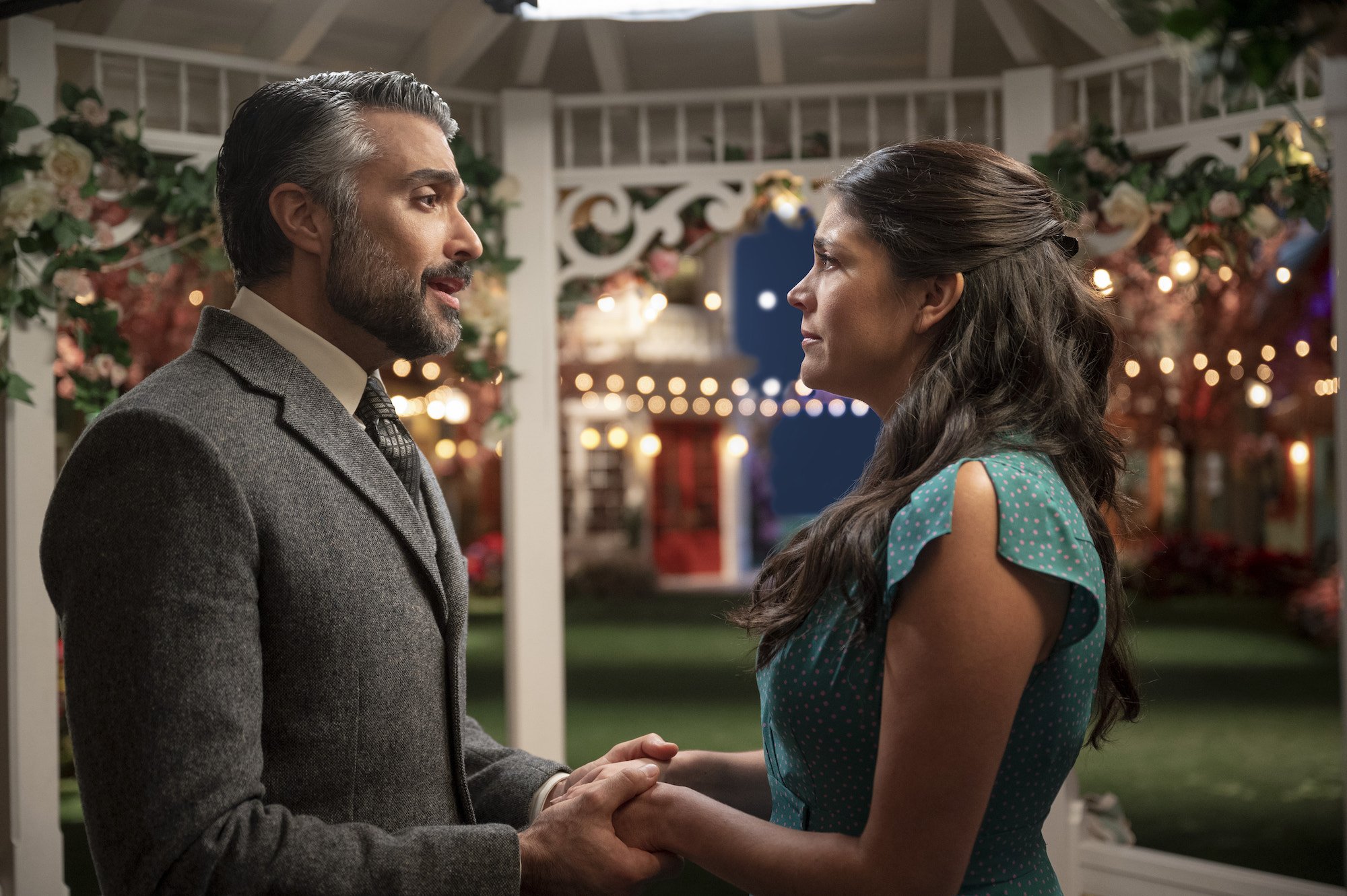 Jaime Camil holds Cecily Strong's hand