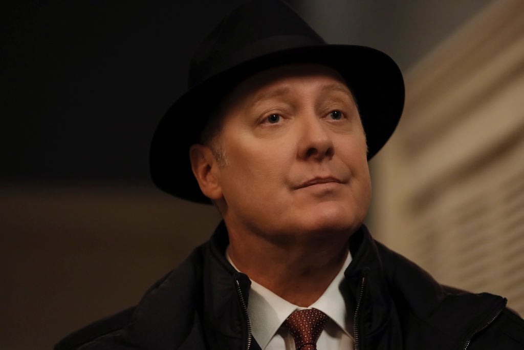 James Spader as Raymond 'Red' Reddington wears his trademark black fedora while looking just off-camera.