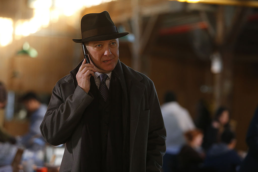 James Spader as Raymond 'Red' Reddington stands outside on his cellphone with a concerned look on his face.