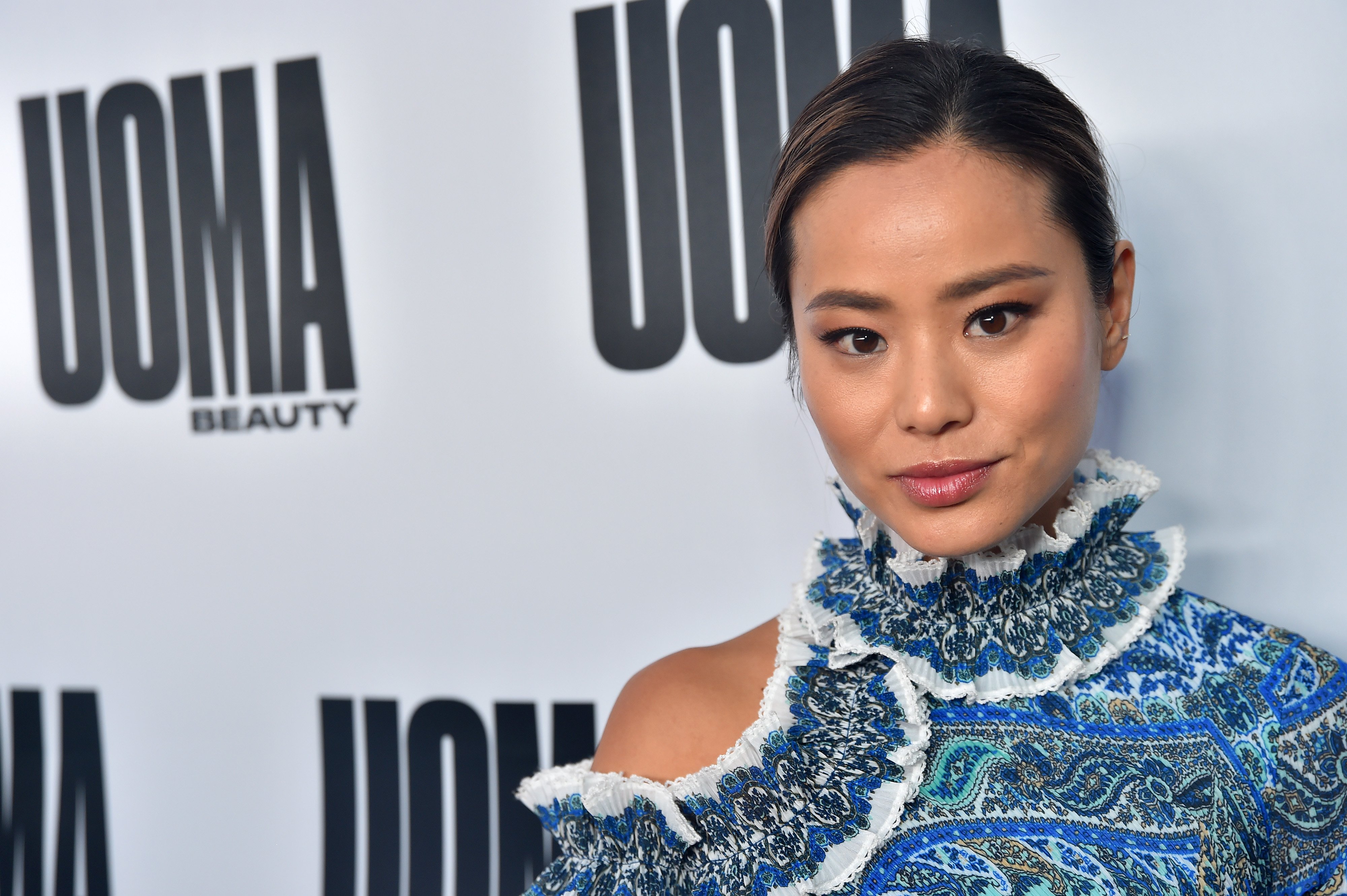 Jamie Chung poses at an event in a blue outfit